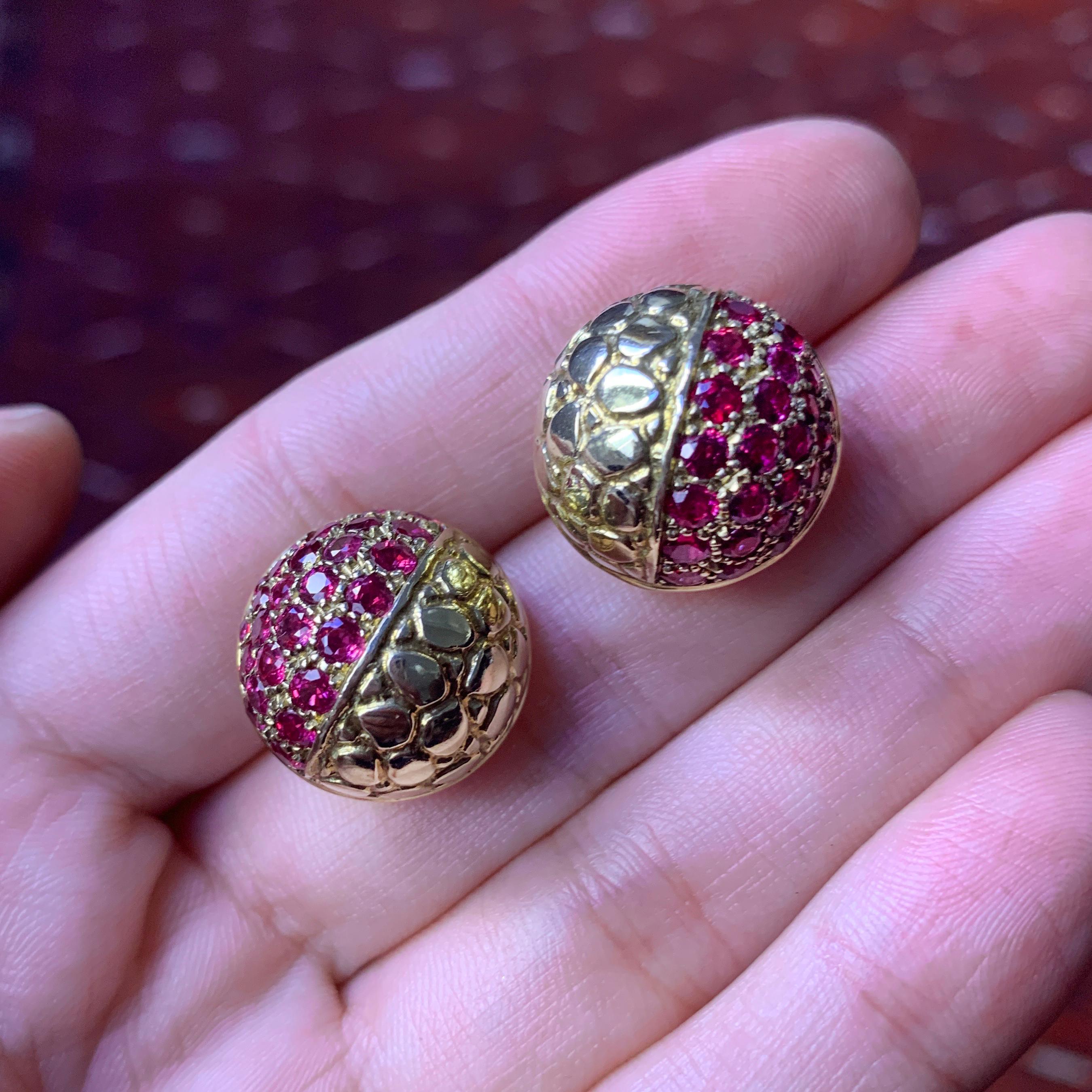 A pair of ruby and 18 karat gold textured earrings, by Gucci, 1980s. 

They are signed Gucci, stamped 750, Italy.

The earrings have a post with omega clip back, but post can easily be removed to convert to a clip-on earring. There is also a