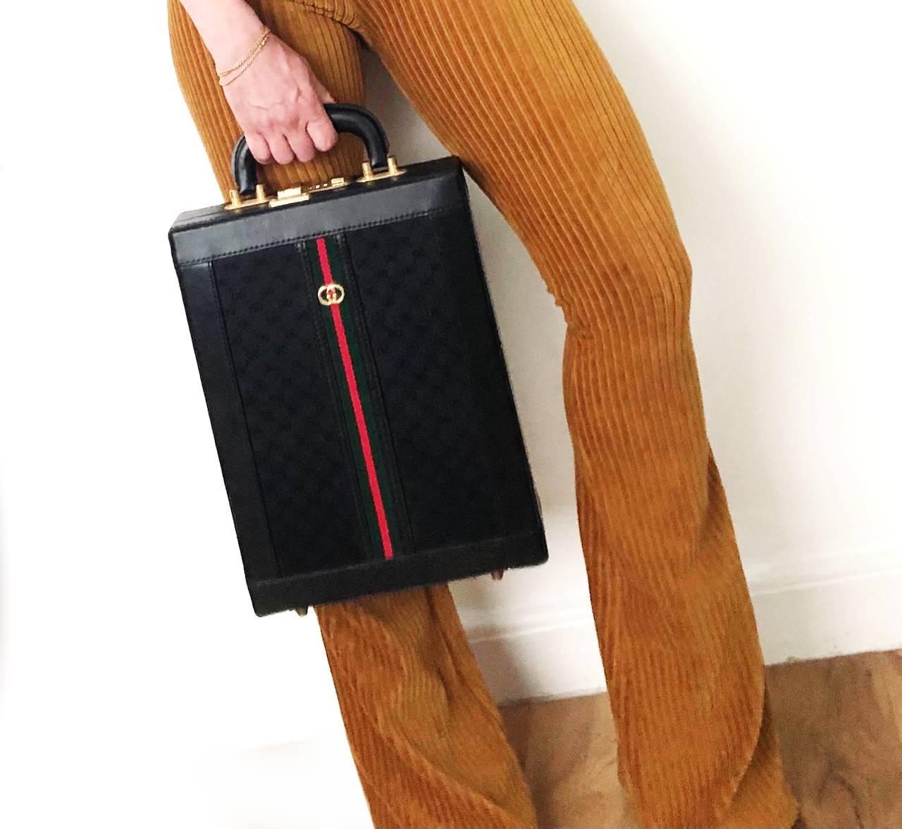 This is the most incredible GUCCI piece! Its a black leather portrait briefcase from the 1980’s collection. With leather trim, suede insert and monogram outside with red and green embellishments and gold logo. An amazing accessory for a meeting and