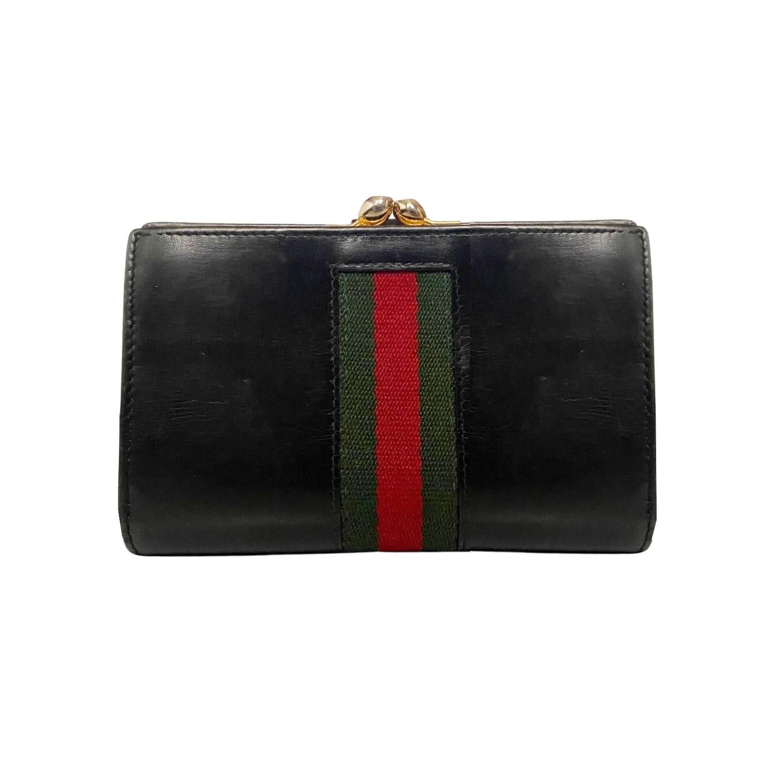 1980s Gucci web wallet, black leather, gold tone metalware, top clutch closure, side compartments, coin compartments, Made in Italy A timeless classic, it's a luxurious addition to any wardrobe and will last for years to come with its durable
