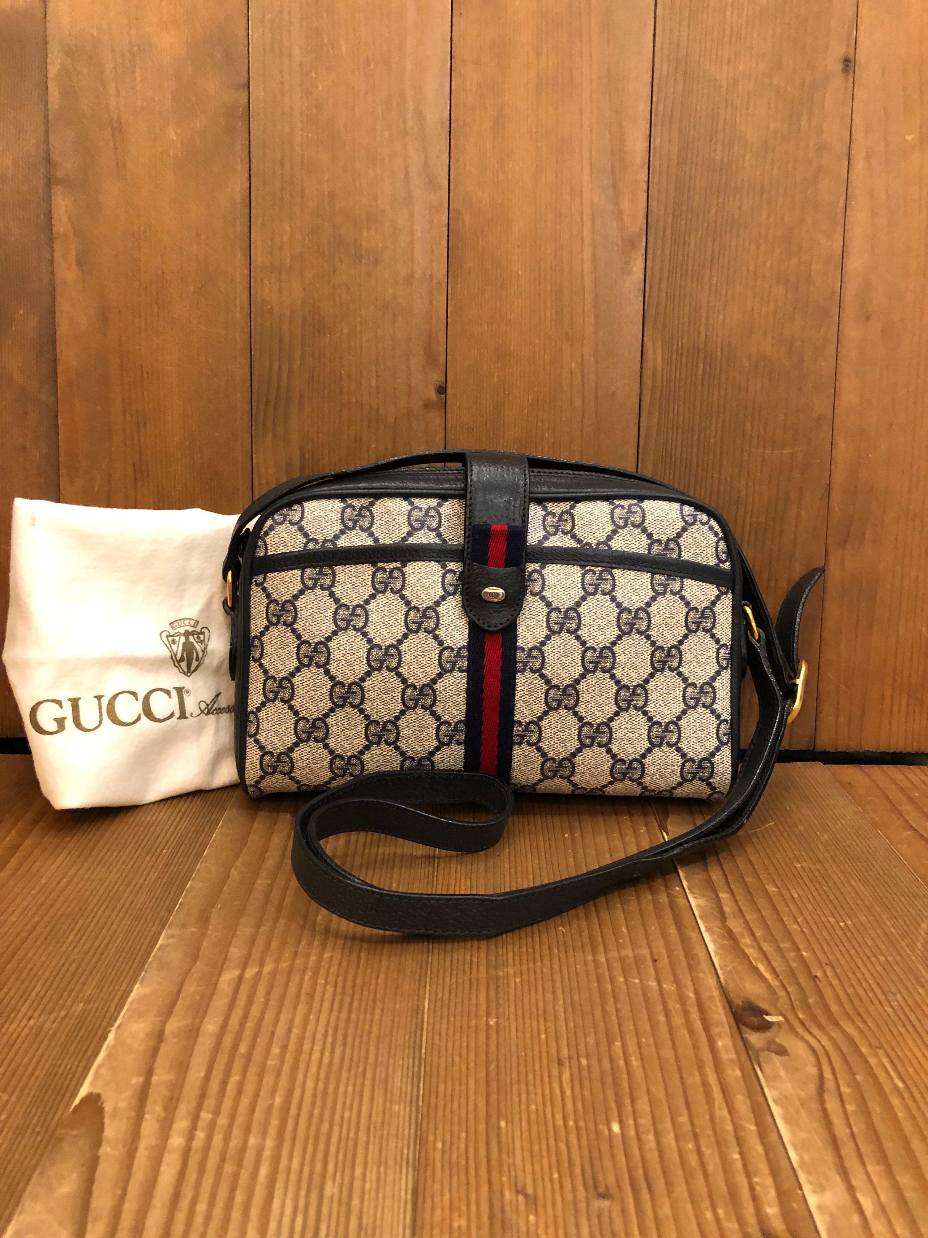 1980s Gucci web small crossbody bag from the 1980s in navy monogram canvas with iconic Gucci navy/red web featuring one front zip pocket with snap closure. Compact in size. Made in Italy. Measures approximately 8.5 x 5.5 x 1.5 Drop 19 inches. Comes