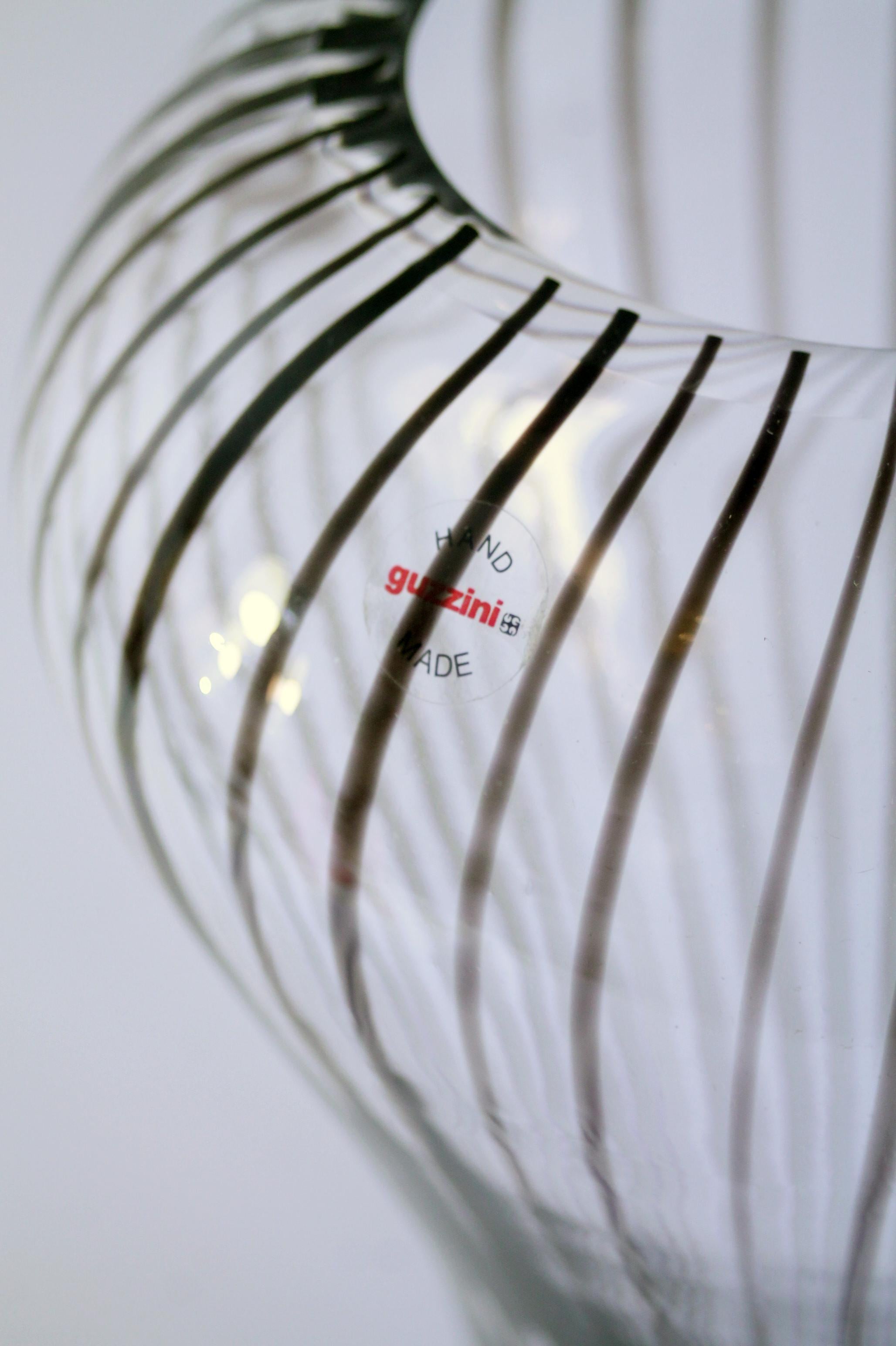 1990s Original Murano mid-century modern retro decor glass vase by Guzzini vetreria

Manufacturer: Guzzini Vetreria (Murano - Italy). etched and still labeled!
Dimensions: 38cm height x Ø 22 cm 
Weight: 5kgs (10 pounds circa)
Condition: In pristine