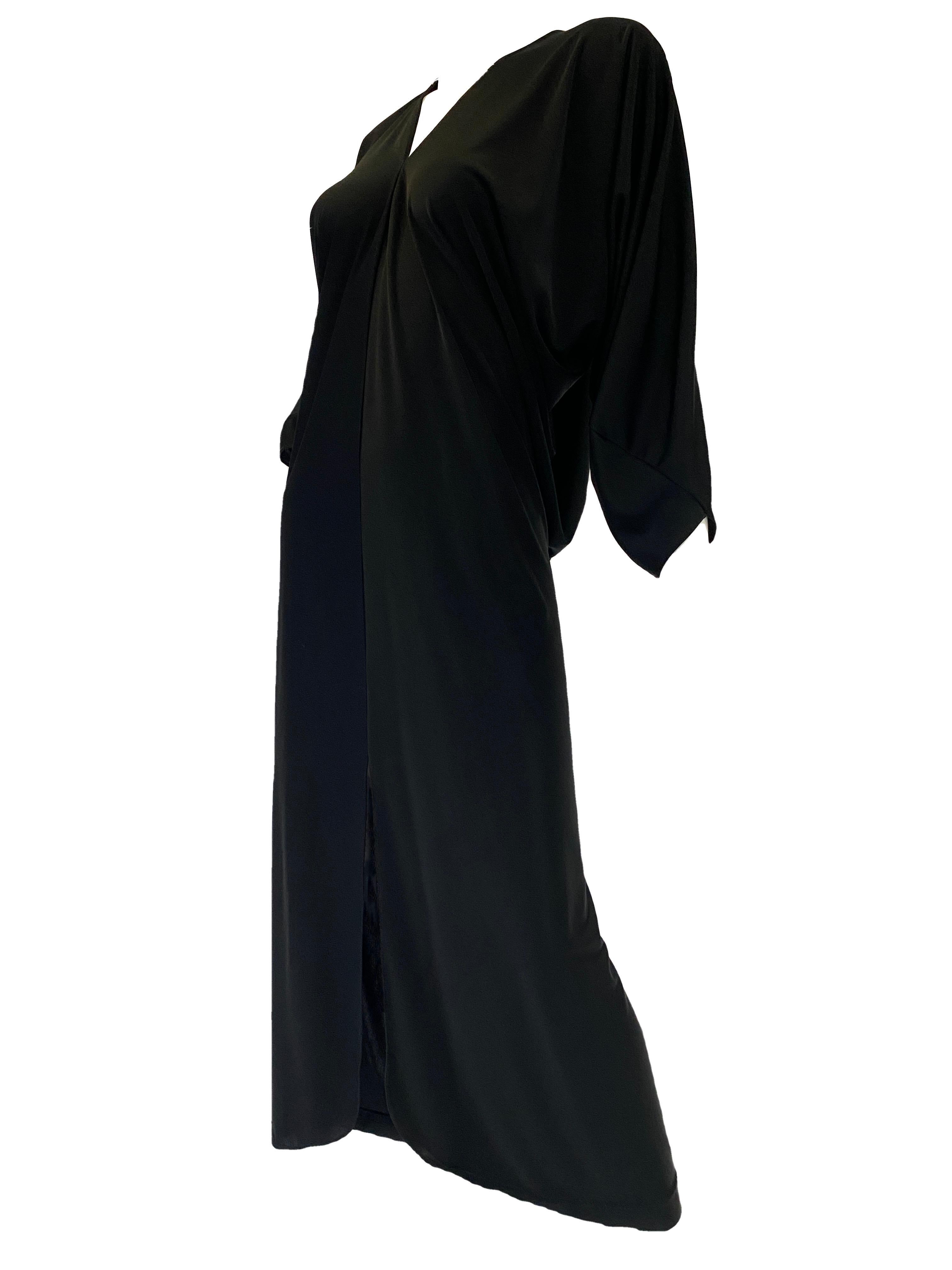 1980s Halston IV Black Jersey Knit Dolman Sleeved Kaftan

Simple, elegant, and small splash of detail: all the components within a classic Halston piece. 

This Kaftan's cut features a deep v neck with a seam the comes down to a slit that allows for