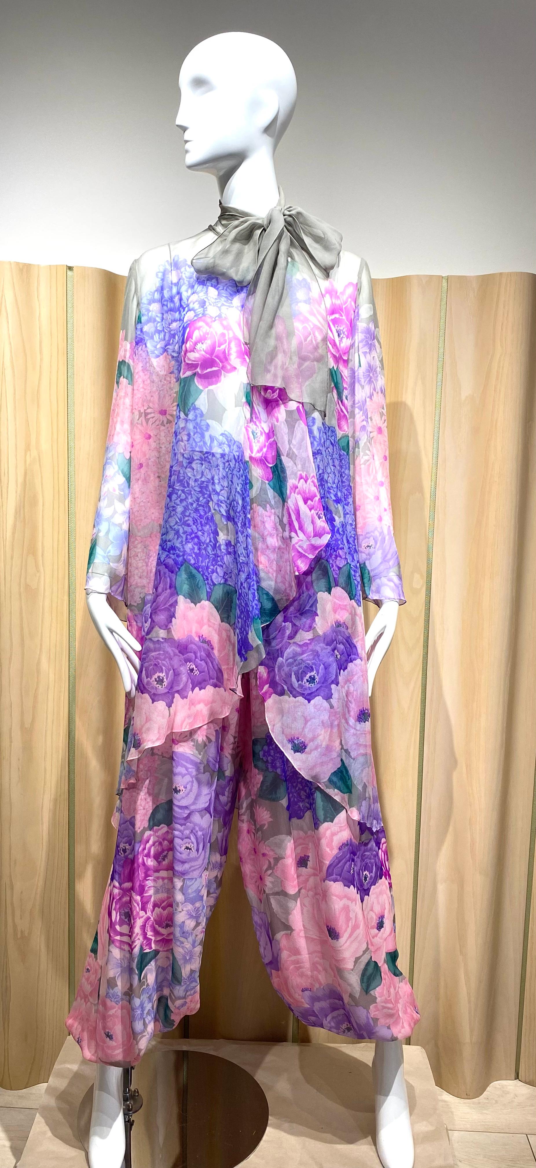 1980s Hanae Mori Silk Chiffon floral print in pink, blue, and purple floral Blouse/ Jacket and pant set . Blouse or Jacket can be worn both way.  Jacket and pant is in excellent condition.
Measurement: 
Blouse ; Bust 40”/ Waist 44” / Hip Open/