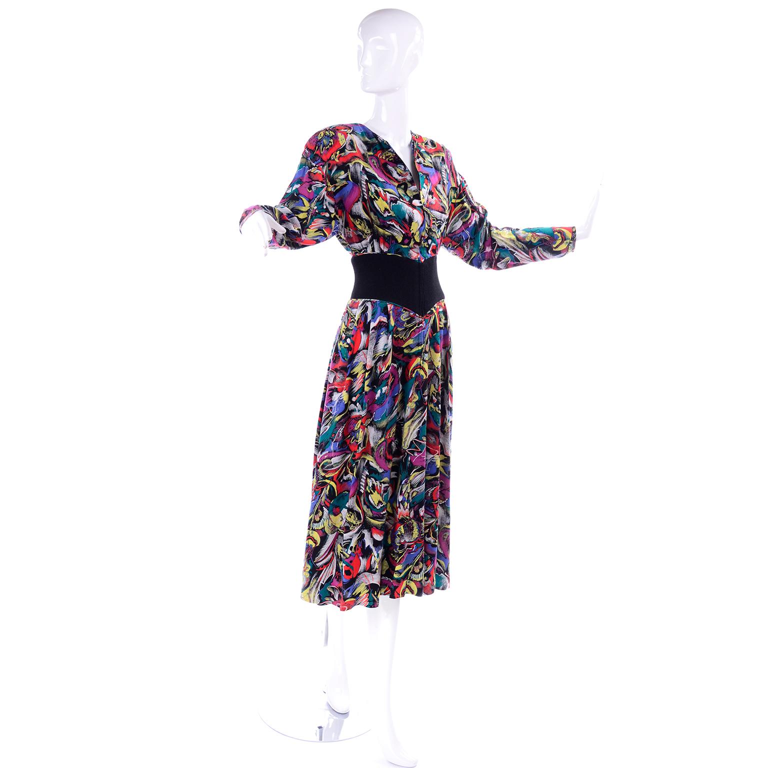 This is a great Hanae Mori 1980's vintage dress in a magenta pink, green, yellow and red artistic abstract design on a black background that looks like chalk! Fully lined with side slit pockets, shoulder pads and drop shoulders. This long sleeve
