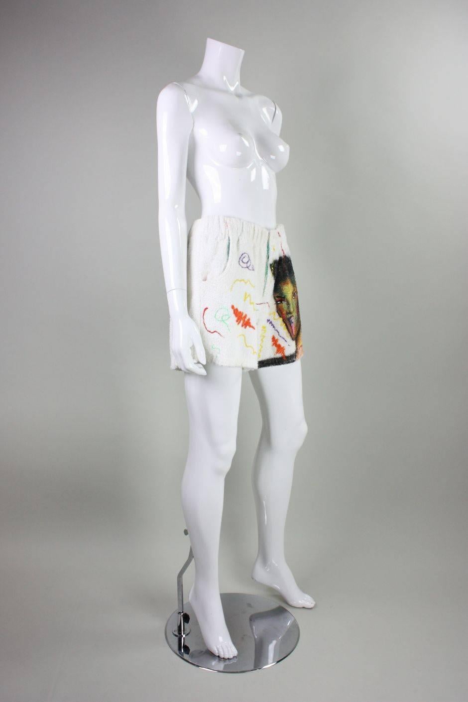 Vintage art to wear shorts date to the 1980's and are made of white terrycloth.  Shorts feature a portrait of Grace Jones painted on the left front leg with puffy paint accents.  Shorts have a Maui and Sons label inside and a 