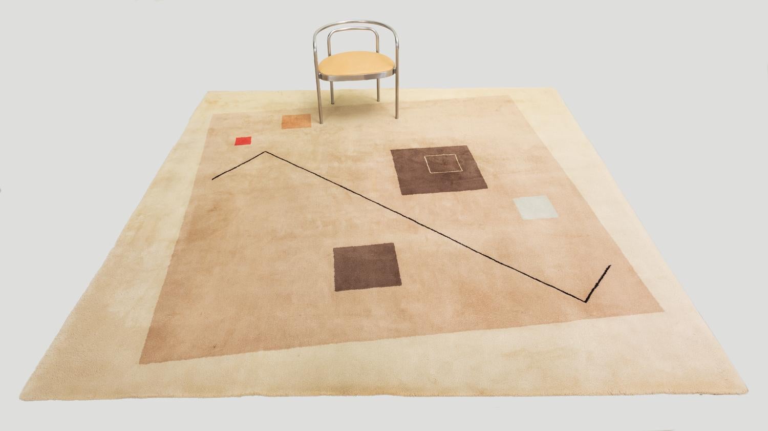 A large square carpet produced in France for Italian textile company Tisca. This collection of hand-tufted rugs featured Eileen Gray-esque configurations of elegantly disjointed geometry in 100% wool fiber. The Minimalist design has a large taupe