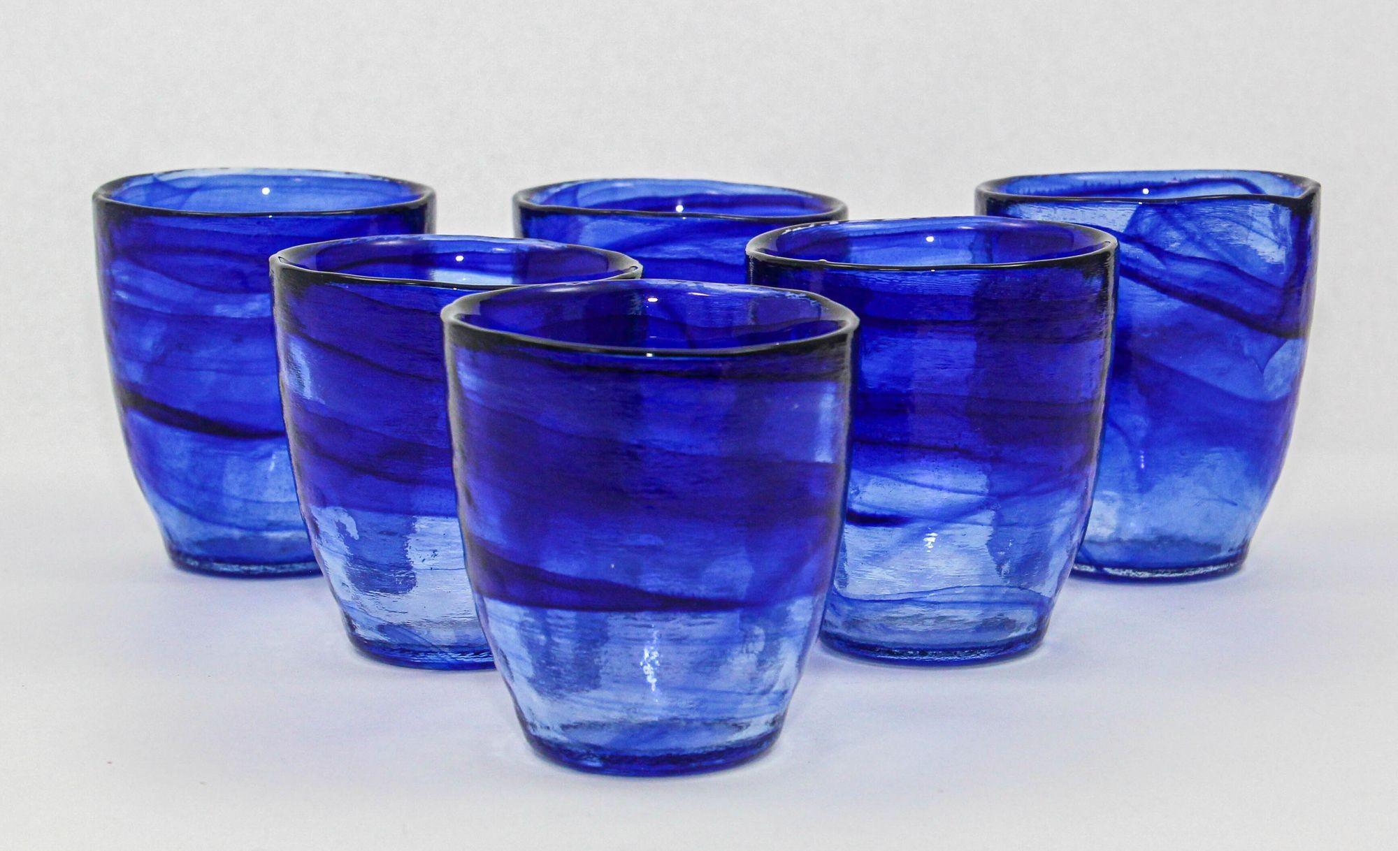 Handcrafted Swirl-Infused Old-Fashioned Glasses in Cobalt Blue – Set of 6.
These vintage Italian hand-blown glasses boast a thick and heavy construction in captivating cobalt blue and clear glass with intricate swirls.
Elevate your barware