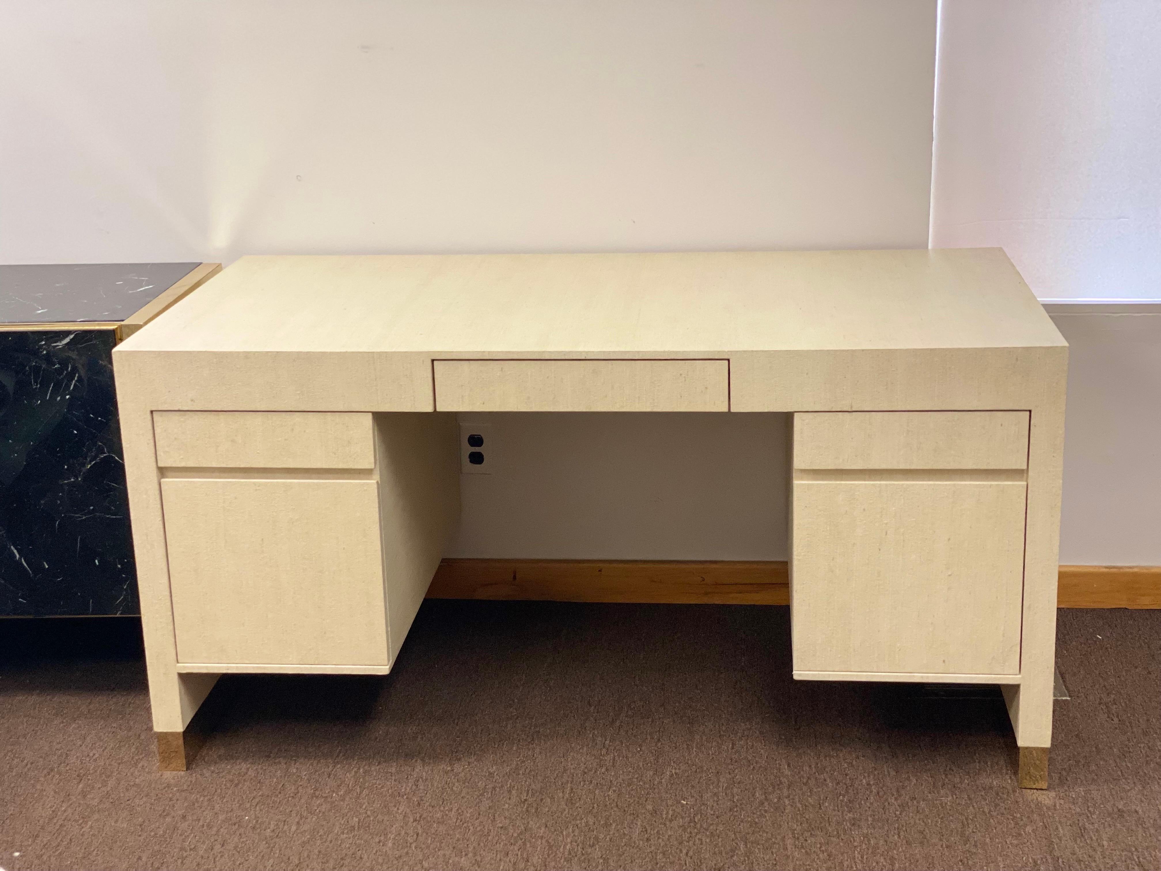 We are very pleased to offer a fabulous pedestal desk attributed to Harrison Van Horn, circa the 1980s. Get down to seriously chic business with this beautiful desk made of hardwood and wrapped in layers of natural grass cloth. Due to the natural