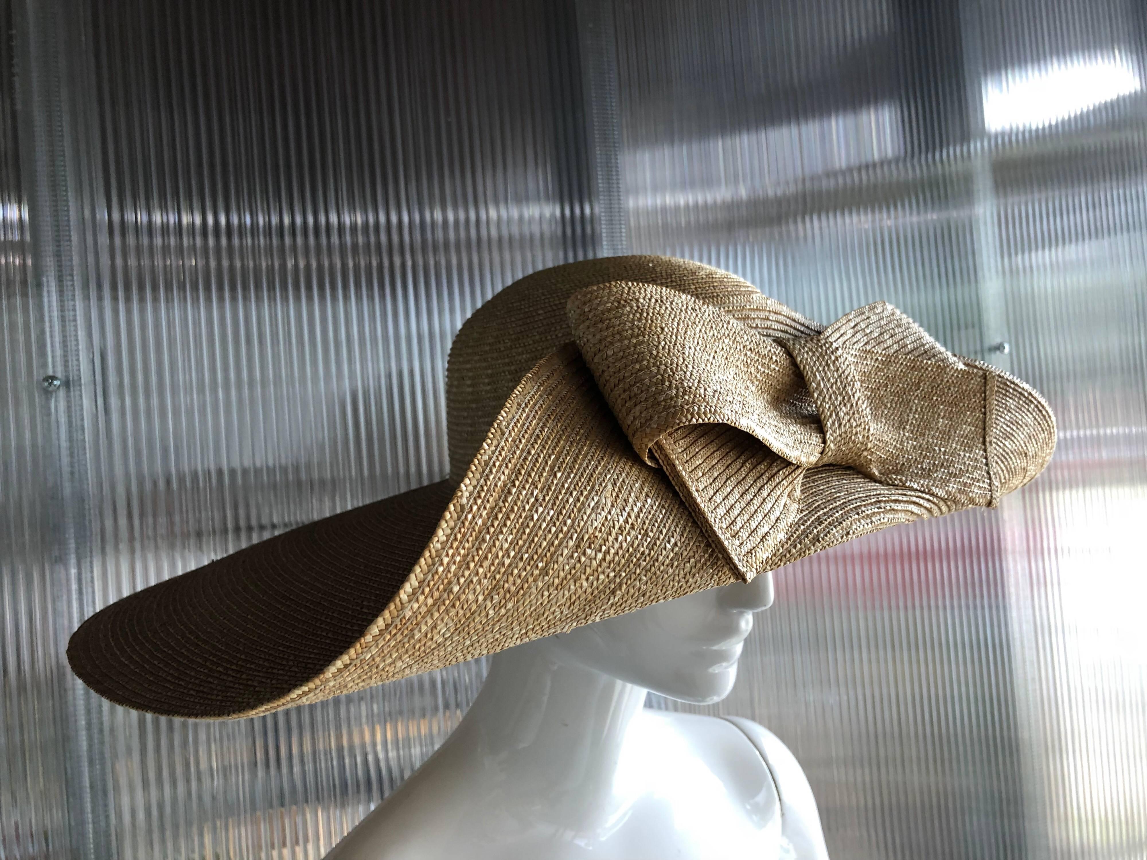 A striking 1980s Helene Berman wide brimmed natural straw hat, with the front brim folded and embellished with a large straw bow!  Perfect for a wedding or the races!  

