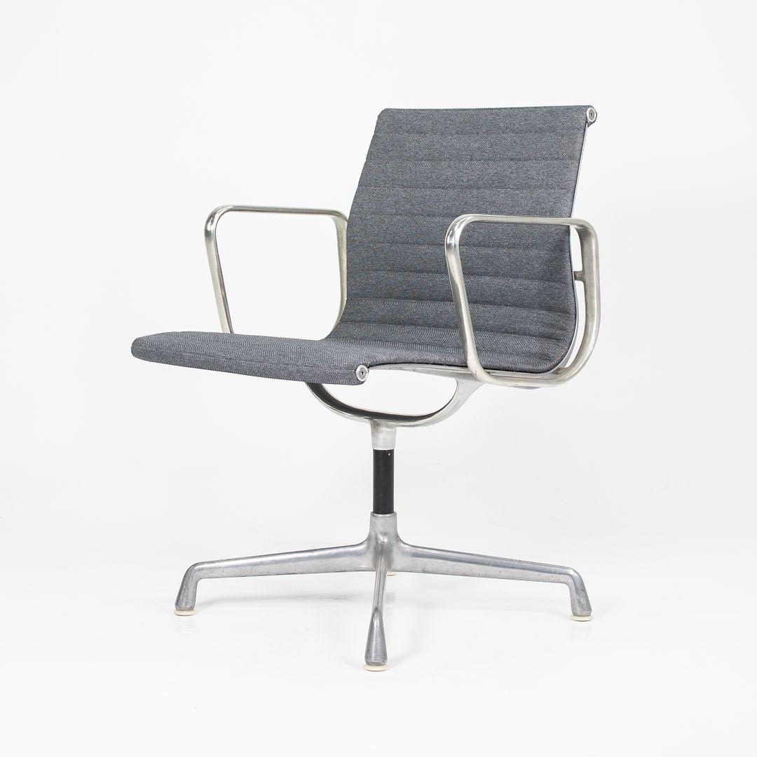 This is an Eames Aluminum Group Management Desk / Side Chair, model EA-108, designed by Charles and Ray Eames for Herman Miller in 1958. This particular example was produced in the 1980s. The design sports a solid yet lightweight die-cast aluminum