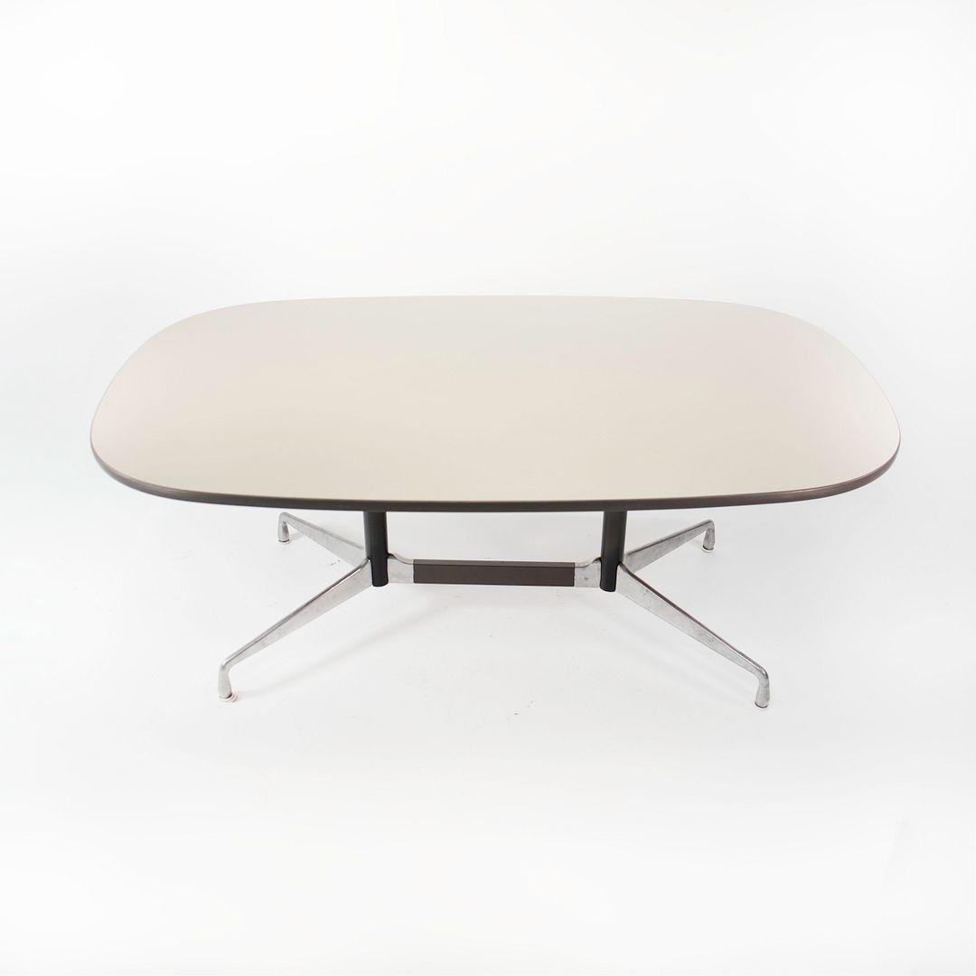 This is a Segmented Conference Dining Table, Model ET151, initially designed by Ray and Charles Eames for Herman Miller in 1964. This piece dates to the 1980s. The table's design is comprised of an aluminum base with a white laminate tabletop. 

The