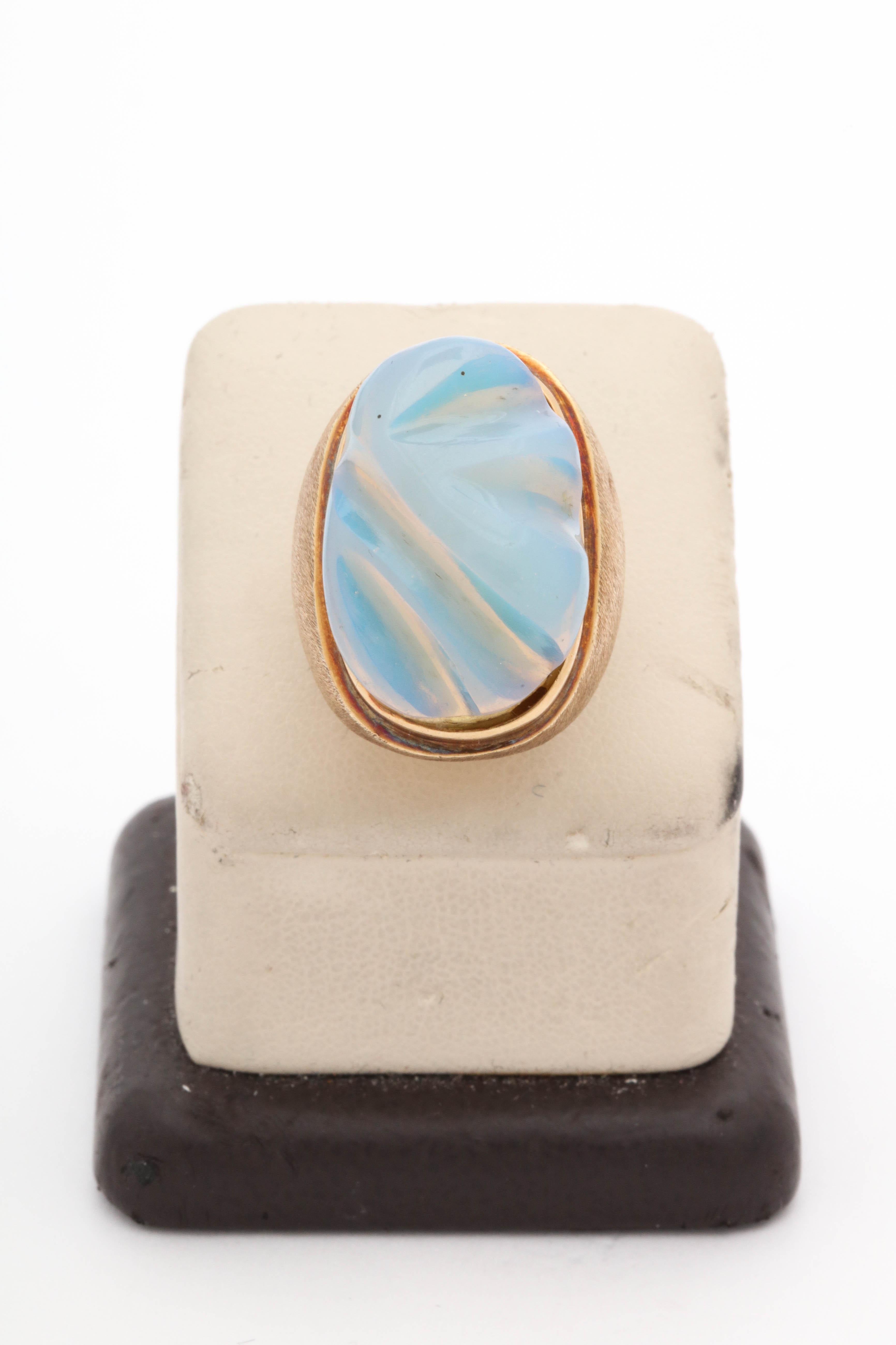 One Dramatic And Unusual Large High Quality Carved  High Iridescent Cocktail Ring Attributed To Burle Marx[ A High End Jewelry Designer From Brazil] This Ring Is Unusual To Find In An Opal! Set In 18kt Gold It Is A True Unusual Beauty. created In
