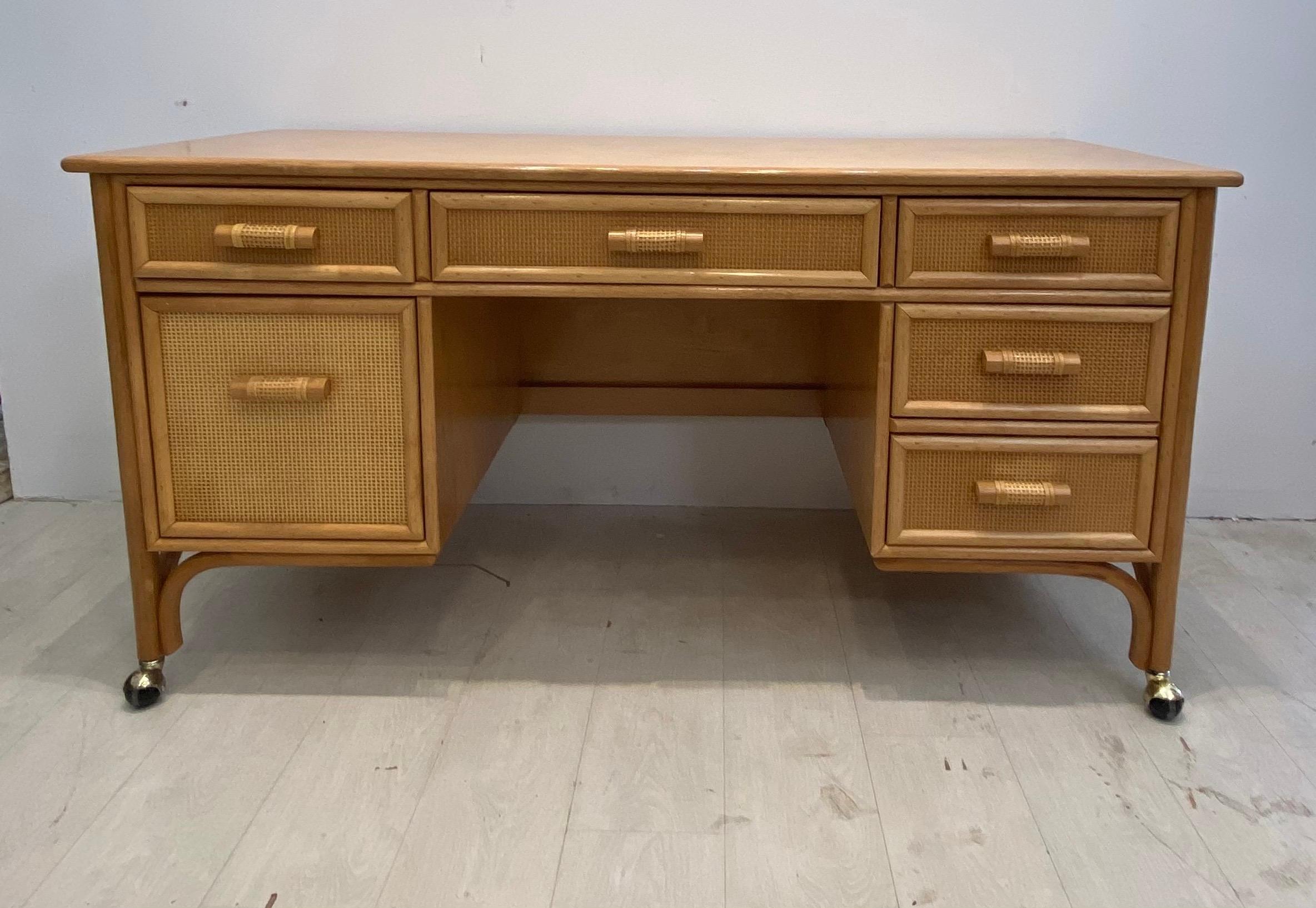 Large desk with 6 drawers. Lots of storage in this large desk. File drawer with 5 other deep drawers. Very well constructed in very good condition. Nice original finish was well cared for. Bamboo look with the strength of rattan.
