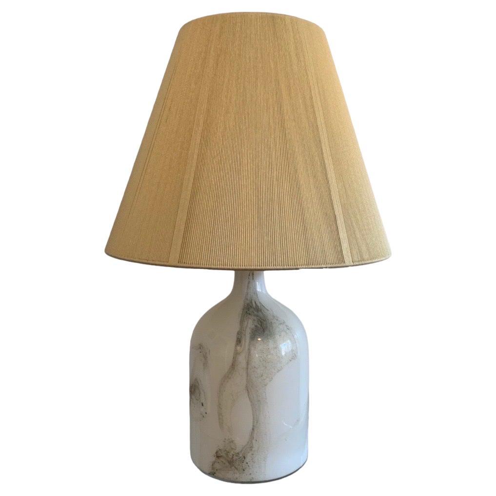 This is an original Danish Holmegaard table lamp, designed by Michael Bang in 1984. Bang designed many pieces for Holmegaard, and this piece is from the 
