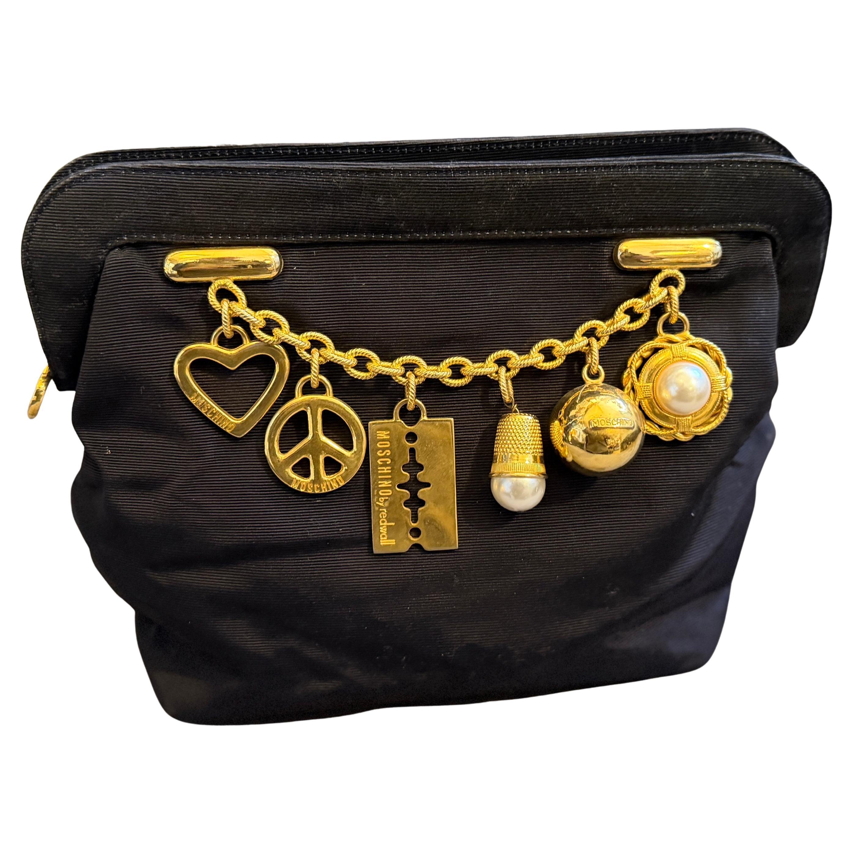 1980s Iconic Black Fabric and Brass Charms Clutch by Franco Moschino