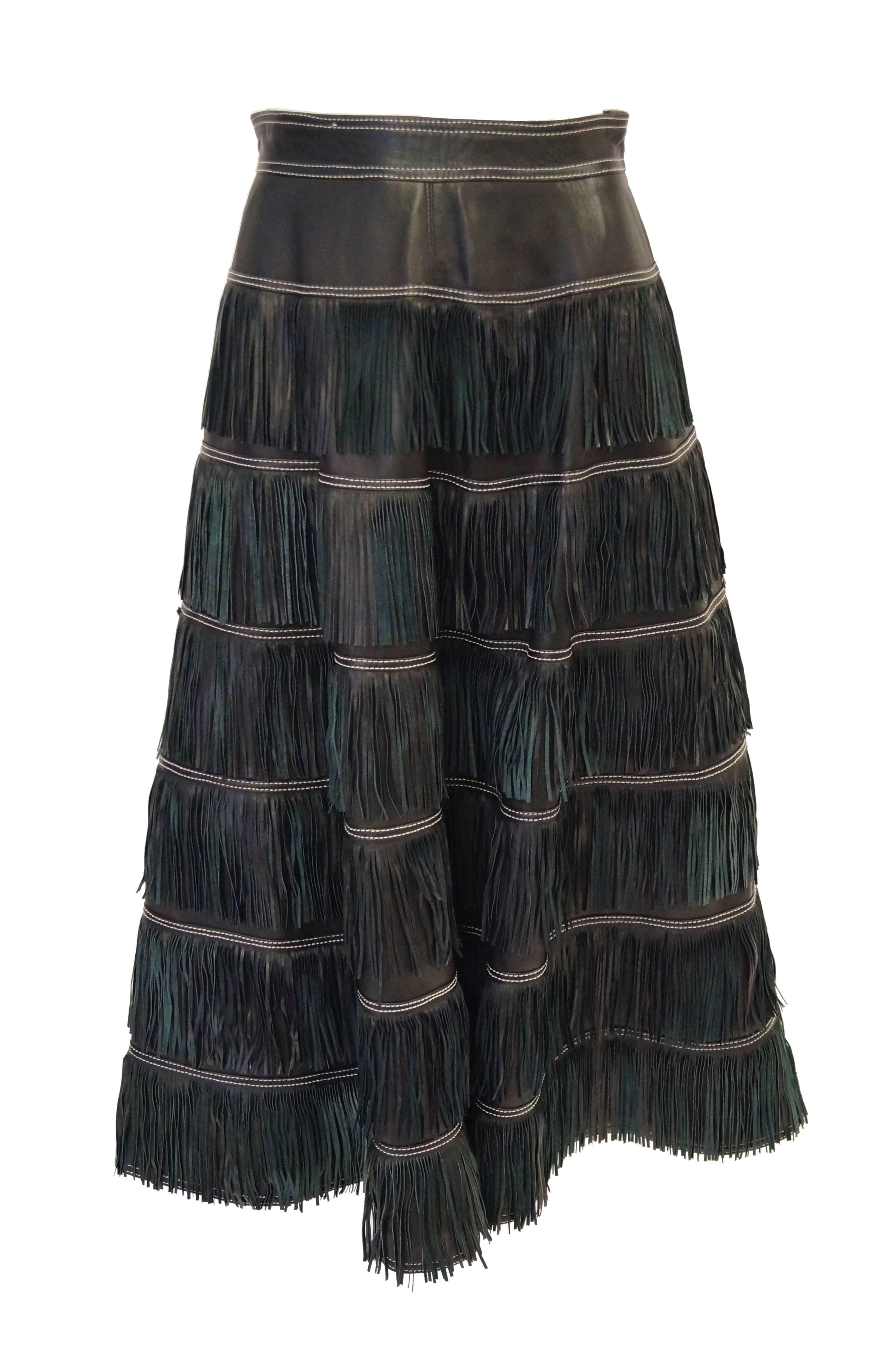 Amazing leather fringe skirt by Gianni Versace! The skirt is midi length, sits at the natural waist, and has five layers of fringe! The skirt features cream accent stitching along the waist and between each layer of fringe. Flashes of dark