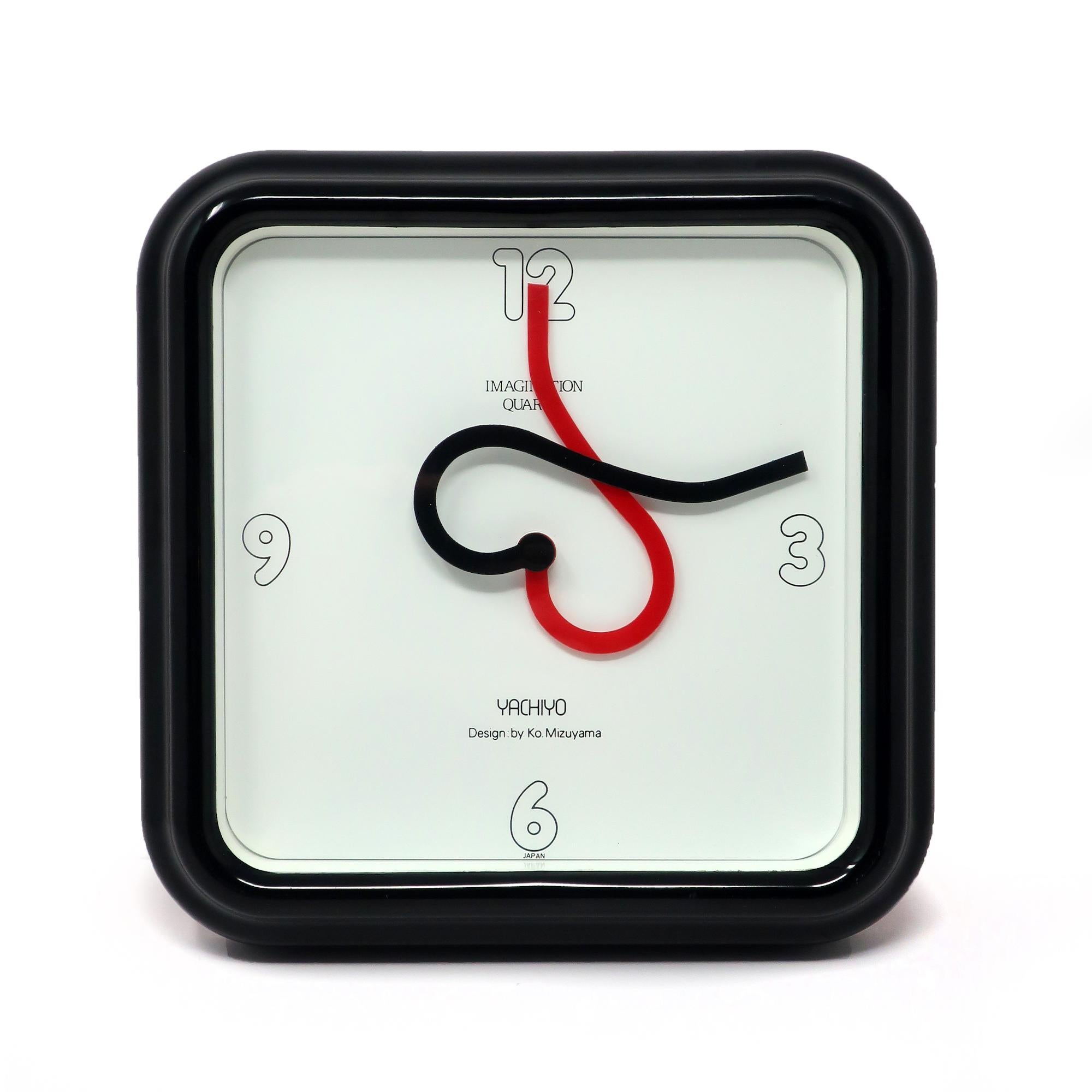 A fantastic wall clock designed by Ko Mizuyama, a prolific Japanese designer of clocks in the 1980s.  It has a black plastic case, white face with black numbers, and red and black hands that form a heart every hour.

In good vintage condition with