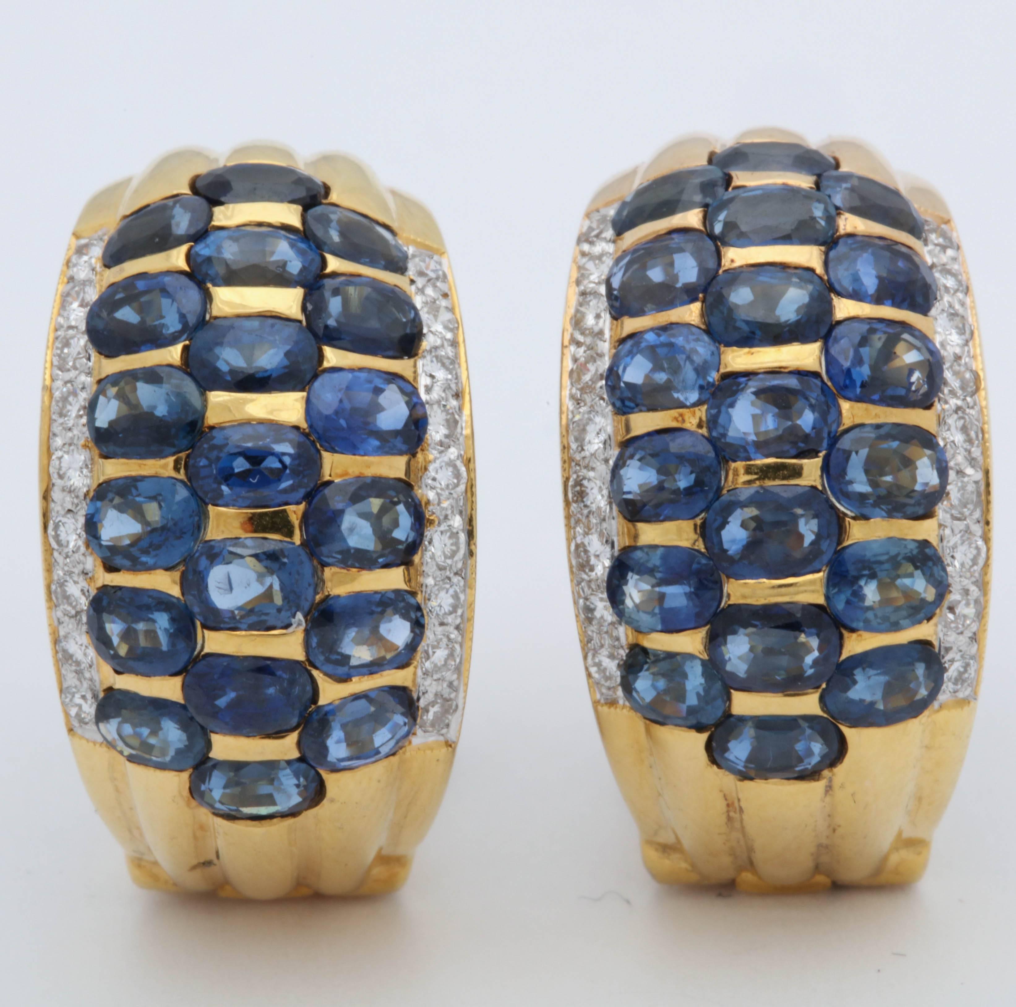 One Pair Of 18kt Yellow Gold Ladies Earclips With Posts Designed With Horizontal Invisible Set Sapphires Weighing Approximately Five Carats Total Weight Of Sapphires. Earclips Are Further Embellished With Four Rows Of High quality Full cut Diamonds