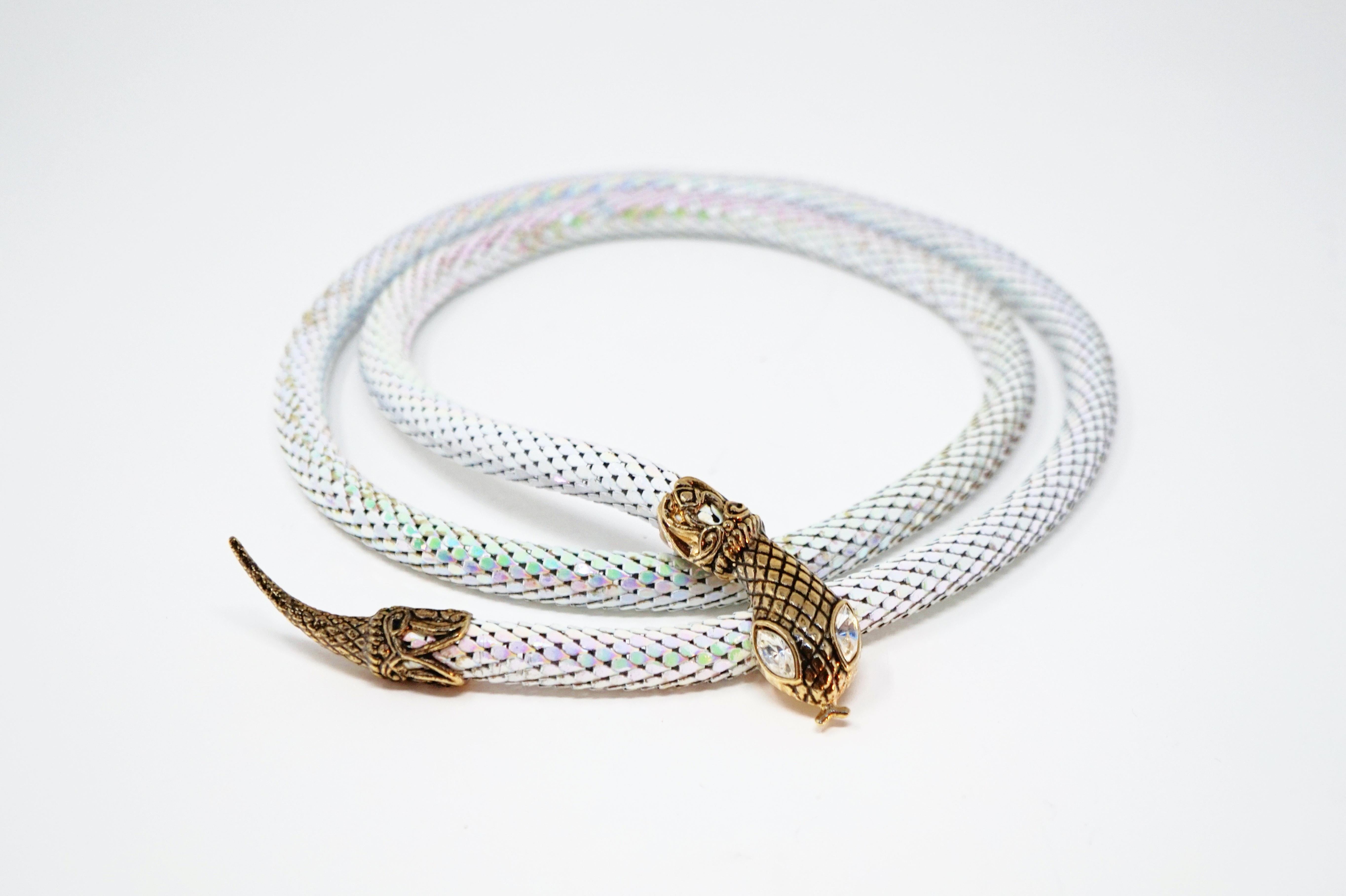 This unique vintage belt, which can also be worn as a necklace, combines iridescent white powder-coated mesh with gold tone snake head and tail embellishments. The golden snake head has crystal rhinestone eyes and hides a belt clip underneath which