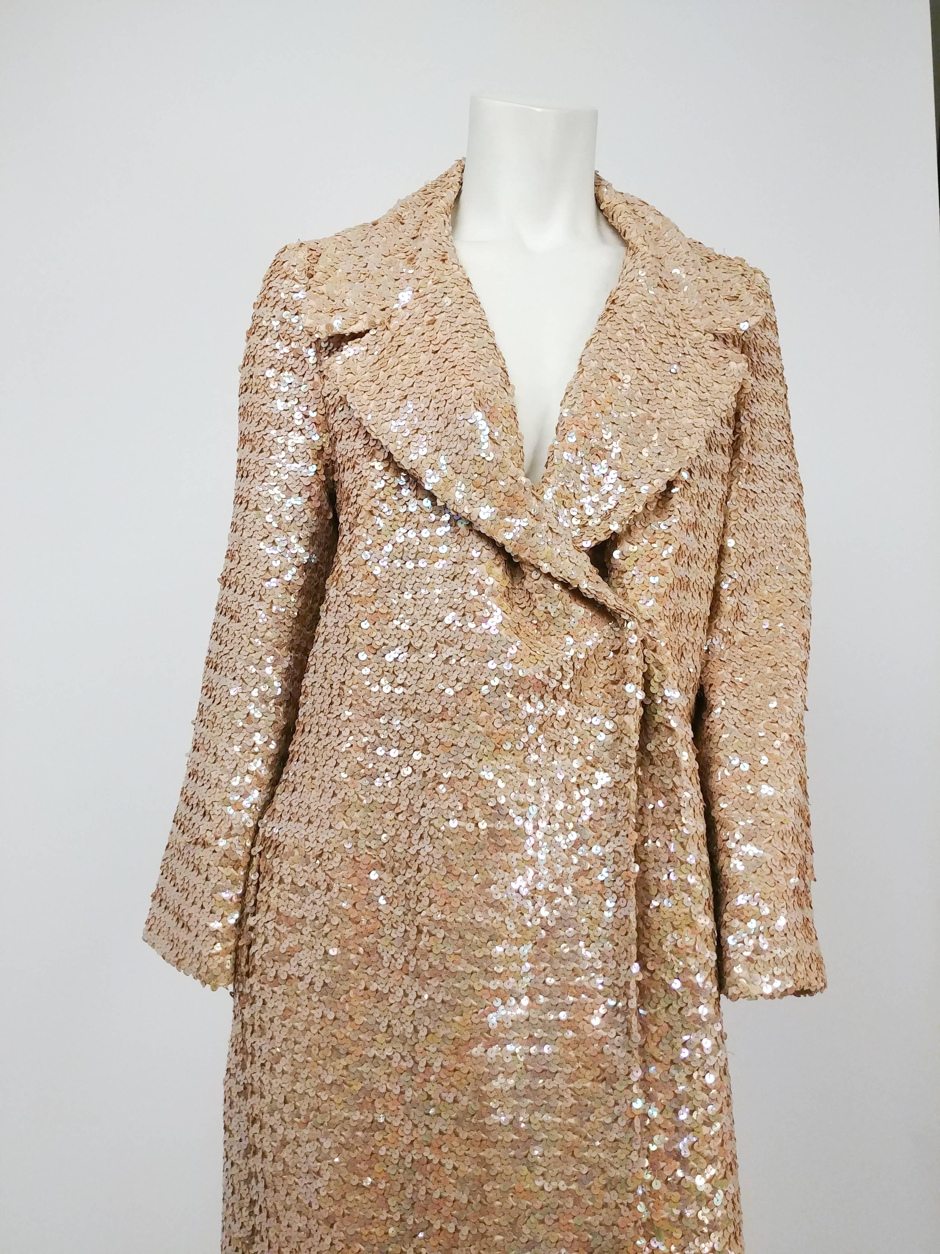 1970s Iridescent Sequin Full Length Long Coat. Hidden snap closure. Wide lapels. A stunning showstopper that will make you never want to take your coat off! 

We have tried this coat on a few of our models who range from size 6 to 12 and due to the