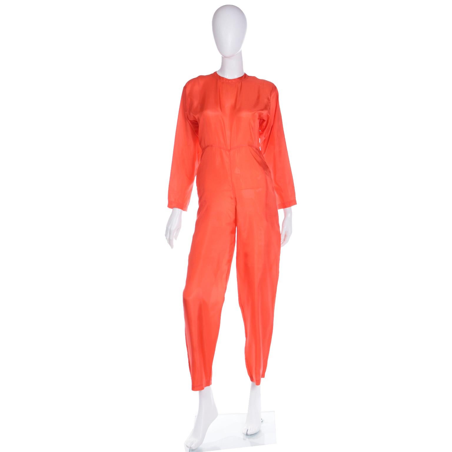 This vintage 1980's Isaac Mizrahi orange jumpsuit is in 100% silk and finding beautiful pieces in fine silk is so much harder today!  The jumpsuit is lightweight and so comfortable to wear and we love the way it fits! This piece closes with a small