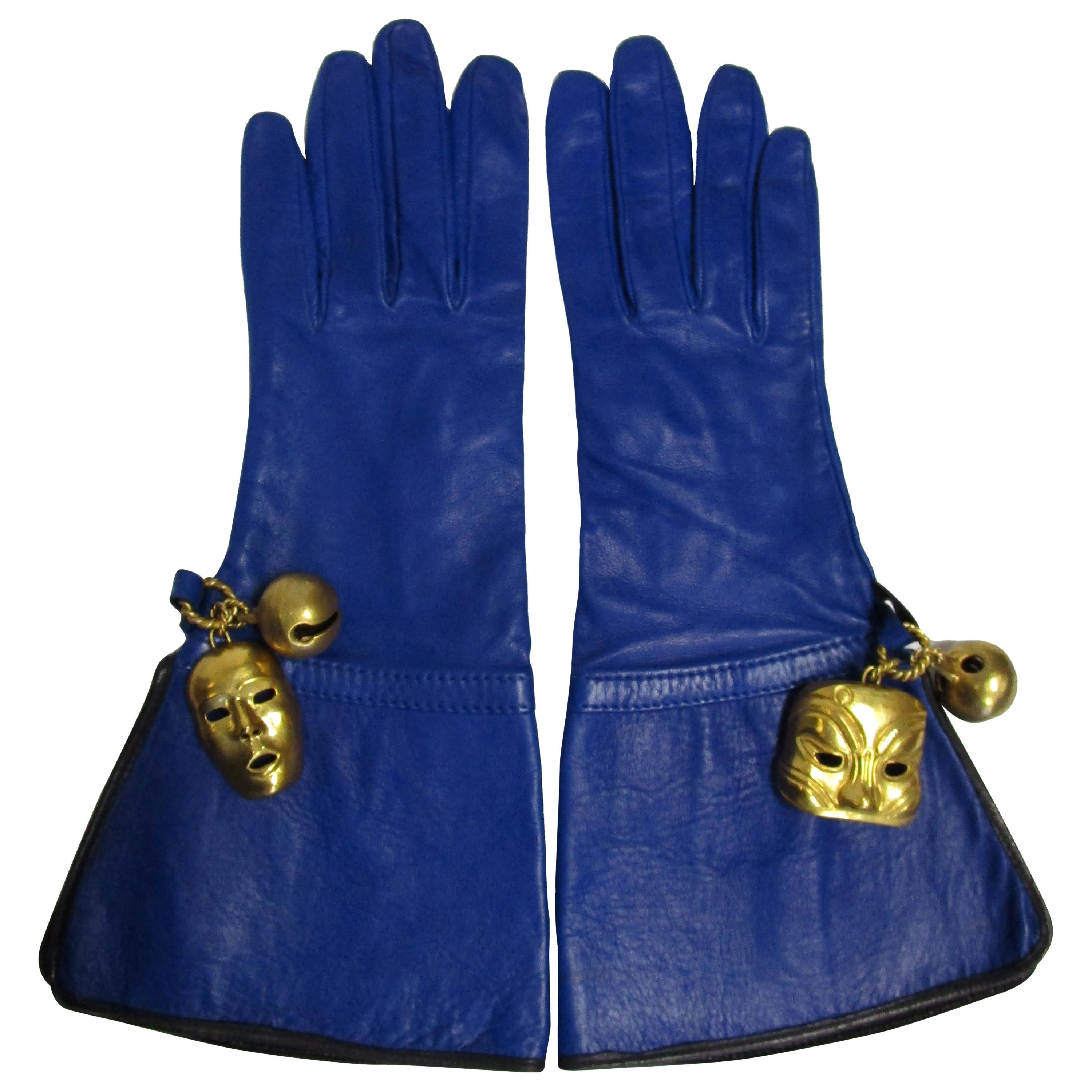 
Breathtakingly designed gloves from Isabel Canovas feature a supple lambskin decorated with theatre muse masks and bells. 

(an excerpt from DKF Estate Jewelry)
Isabel was born in Paris in 1945. Her Spanish father Blas Canovas was a couture textile