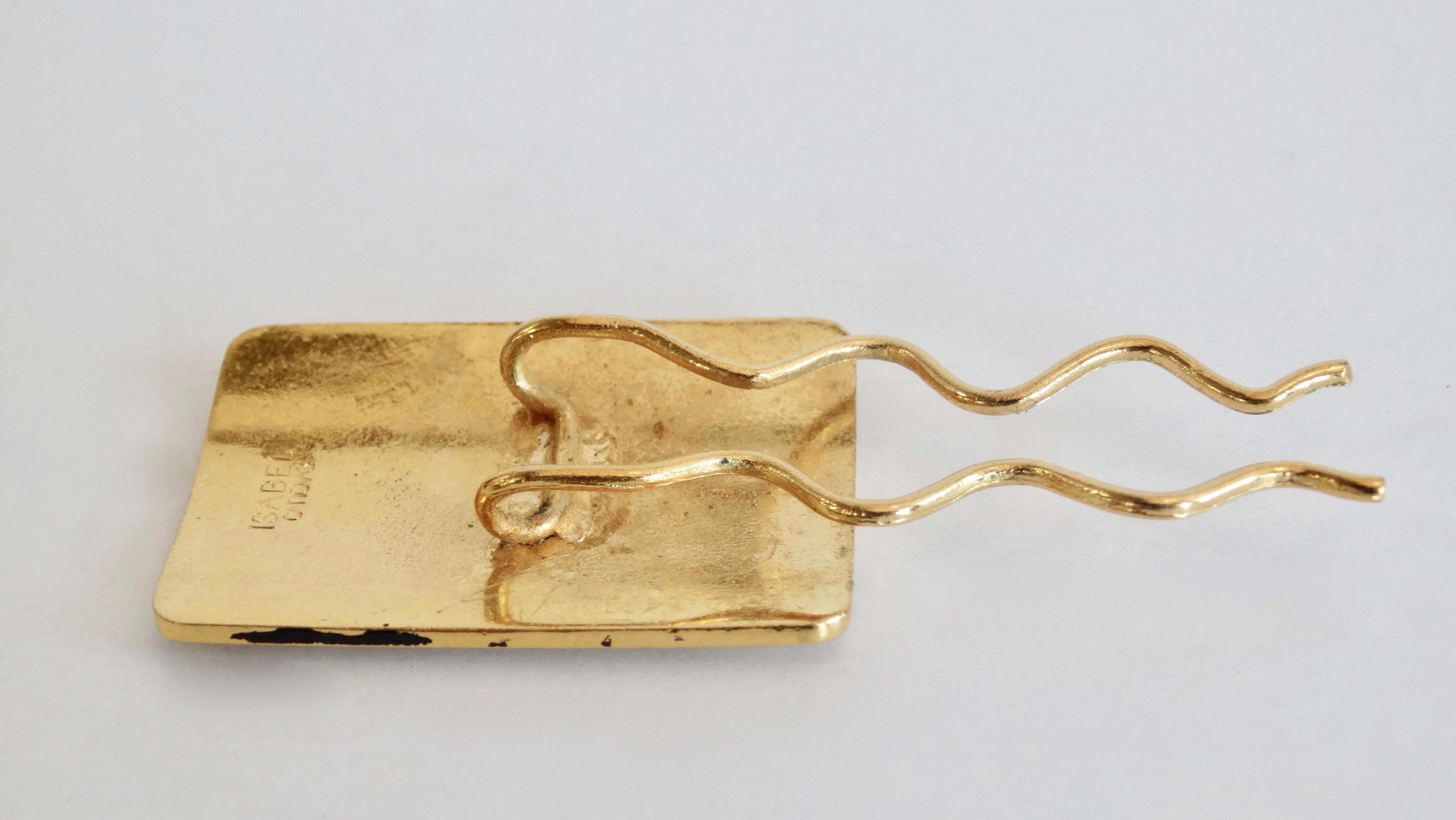 Spice up your up-do with this adorable Isabel Canovas hair pin! Circa 1980s, this gold plated rectangular hair pin features a carved motif reminiscent of the Baroque period. Looks adorable pinned in a bun! 

Note: Isabel was born in Paris in 1945.