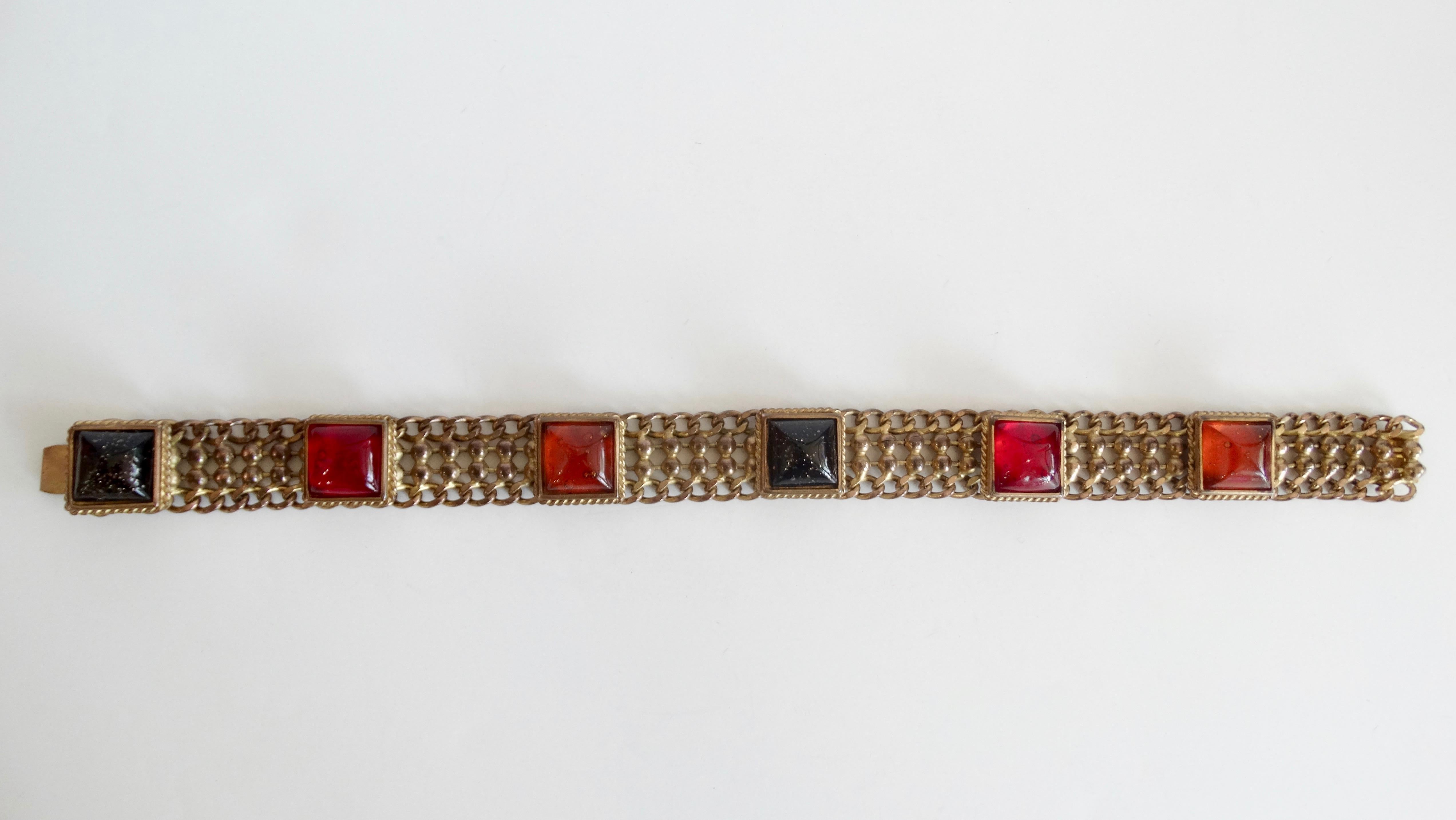 Spice up your jewelry collection with this amazing Isabel Canovas choker! Circa 1980s, this multi chain brass choker features square Gripoix gems, a poured glass technique,  in gold speckled black, orange and red. Includes a box clasp closure. The