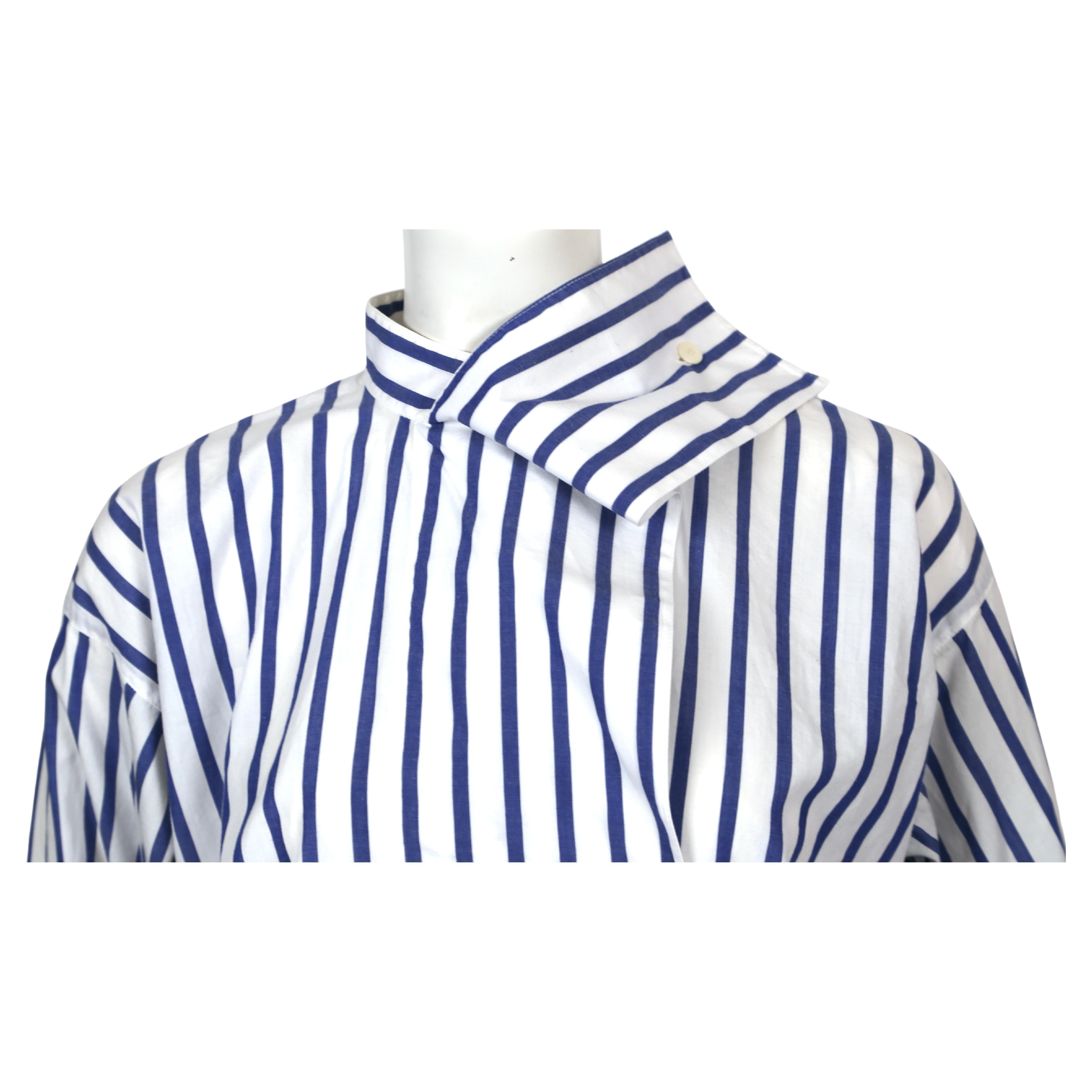 Blue and white striped cotton shirt with draped neckline and asymmetrical button closure designed by Issey Miyake dating to the early 1980's. Labeled a size 'S', however this shirt fits oversized and will fit many sizes. Approximate measurements