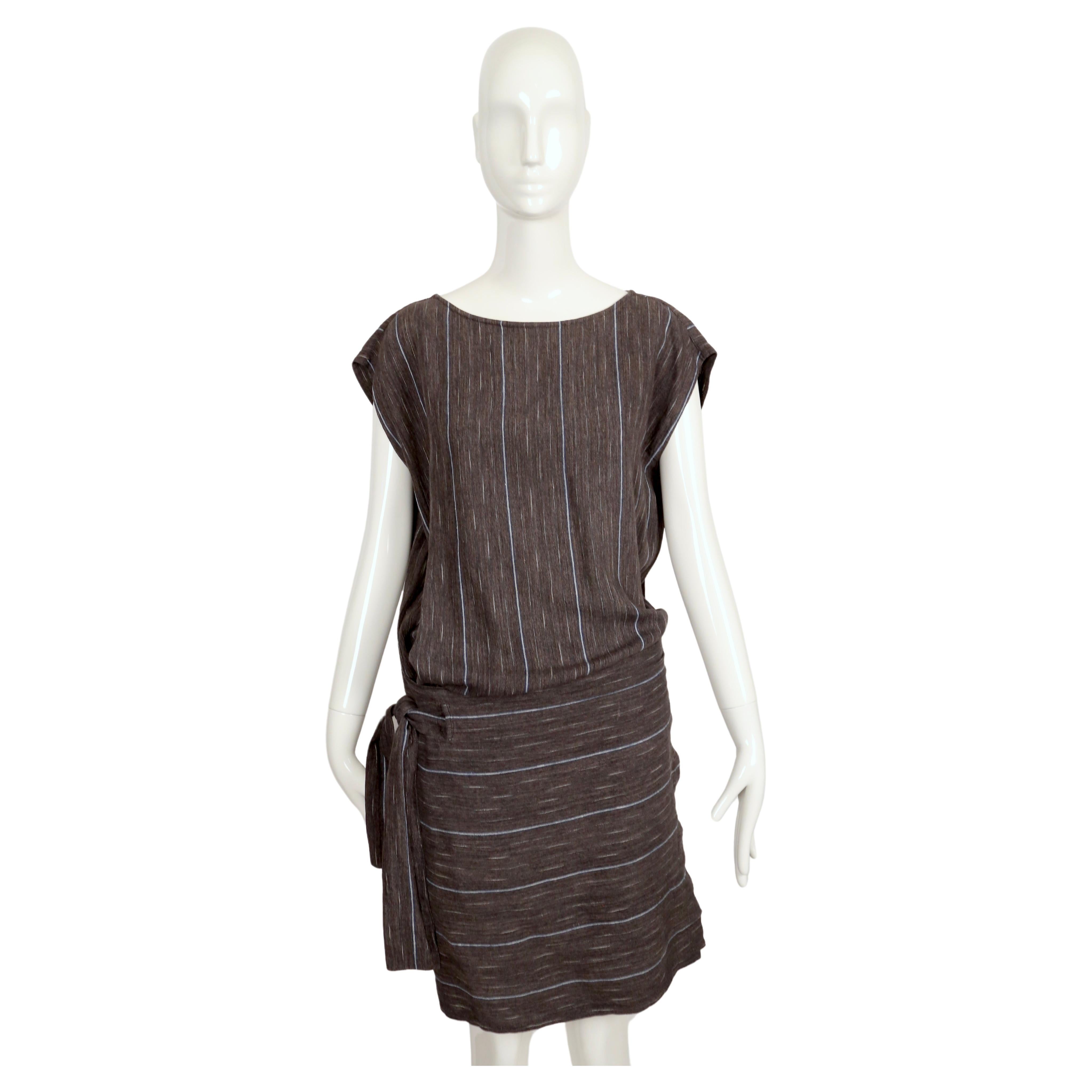 Charcoal grey, blue and off-white Ikat woven wrap dress from Issey Miyake dating to the 1980's.  Dress is labeled a Japanese 9. It best fits a size XS to M. There is some flexibility due to the wrap style. Approximate measurements are: bust 46