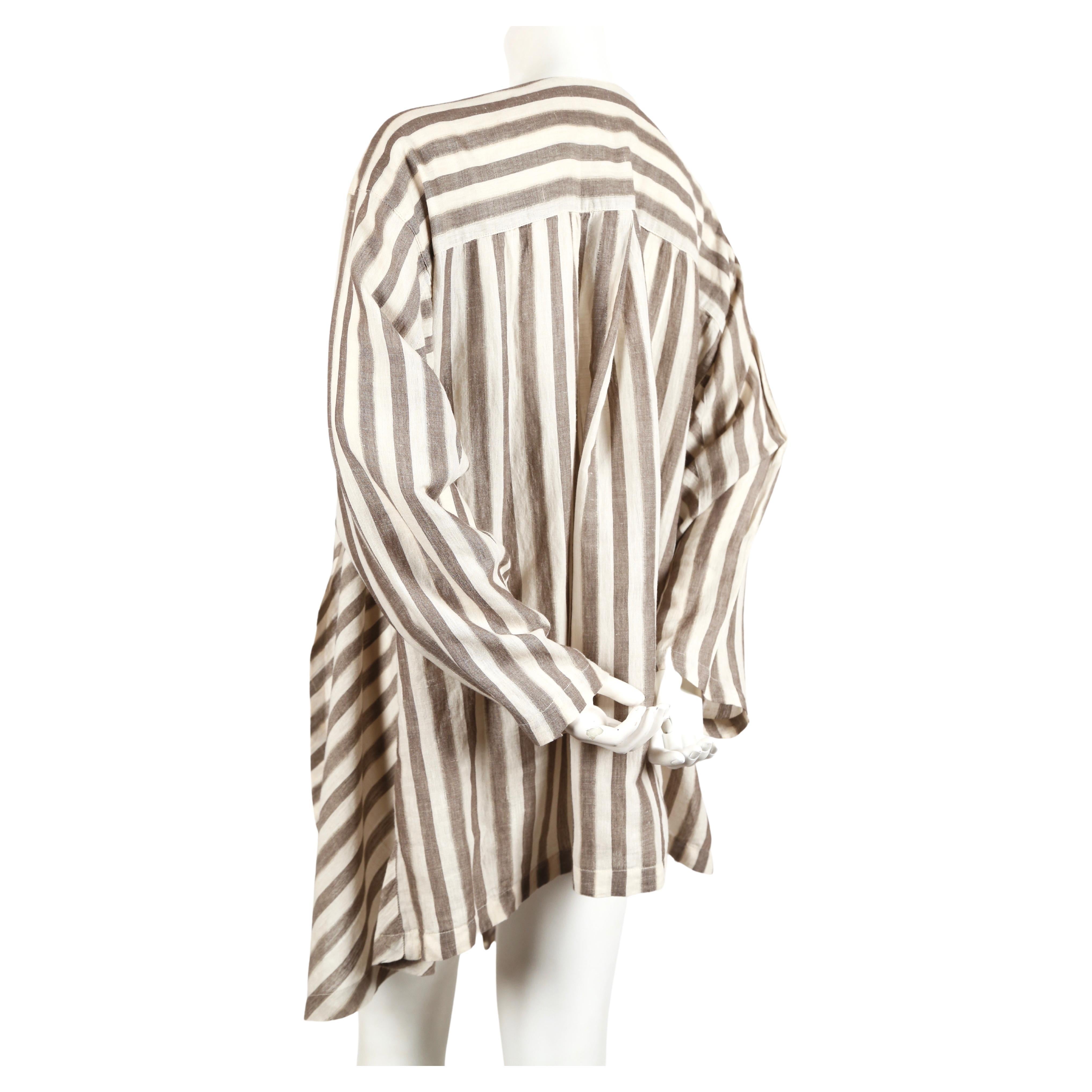 Very lightweight striped cotton jacket with asymmetrical cut designed by Issey Miyake dating to the early 1980's. No size is indicated however this will fit many sizes due to the oversized cut. Open closure. Very good condition. 