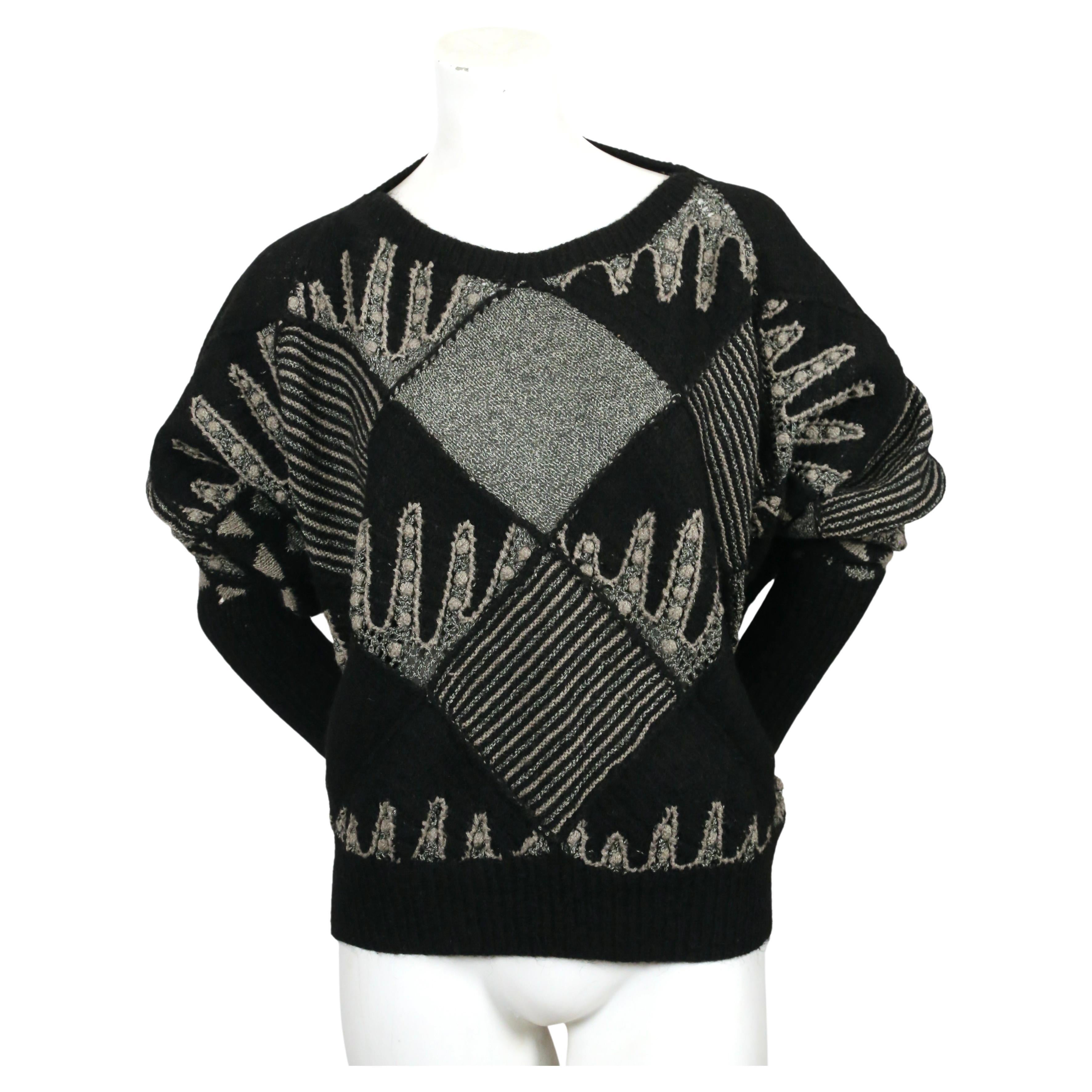 Very rare, geometric knit sweater with dolman sleeves designed by Issey Miyake dating to the early 1980's. Sweater features several different knitting techniques. Labeled a size M. Approximate measurements: bust 56