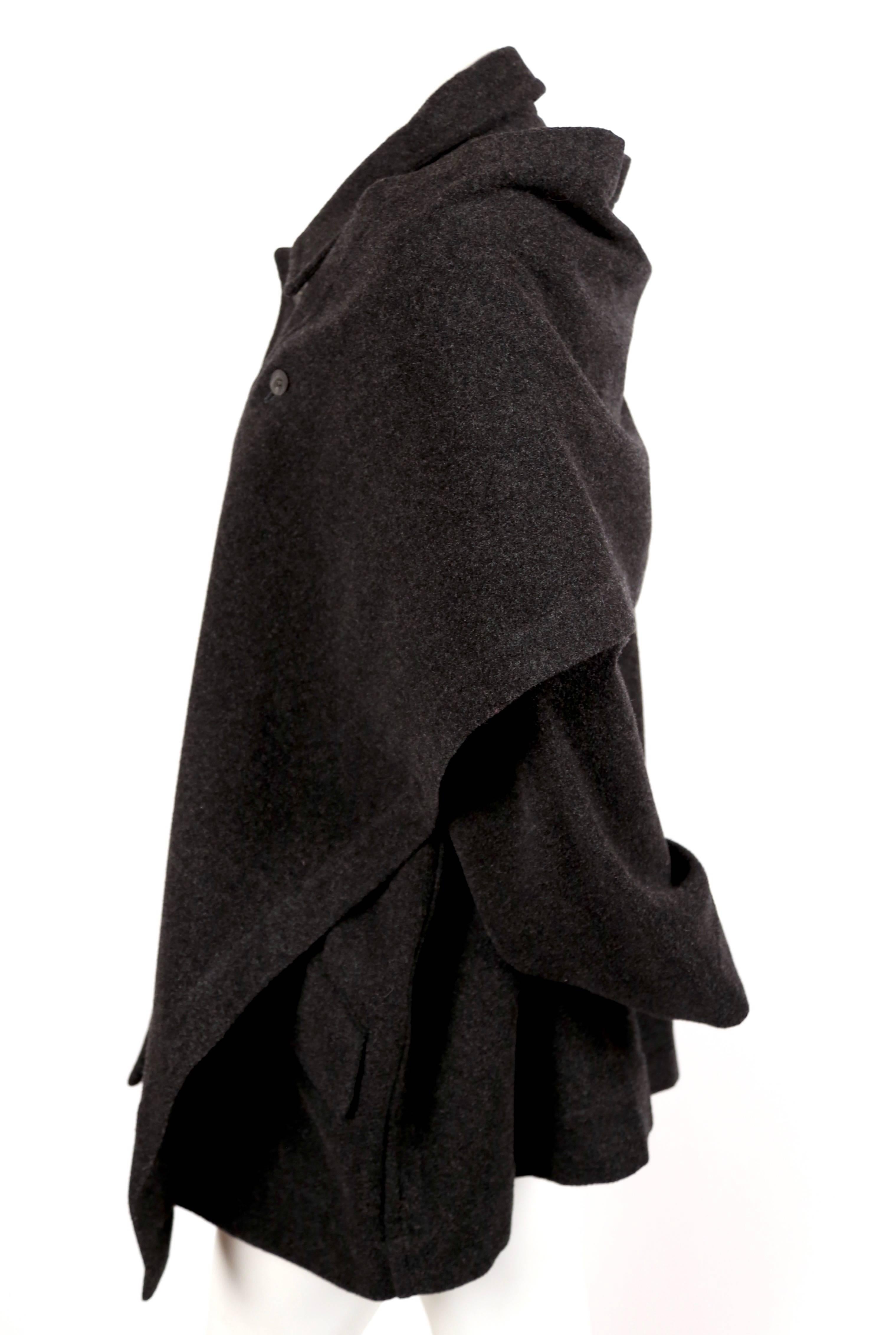 Deep charcoal wool coat with removable draped scarf designed by Issey Miyake for Plantation dating to the 1980's. Size 'S' however it is a very oversized fit so it will fit many sizes. Approximate measurements: shoulder (dropped) 22.5
