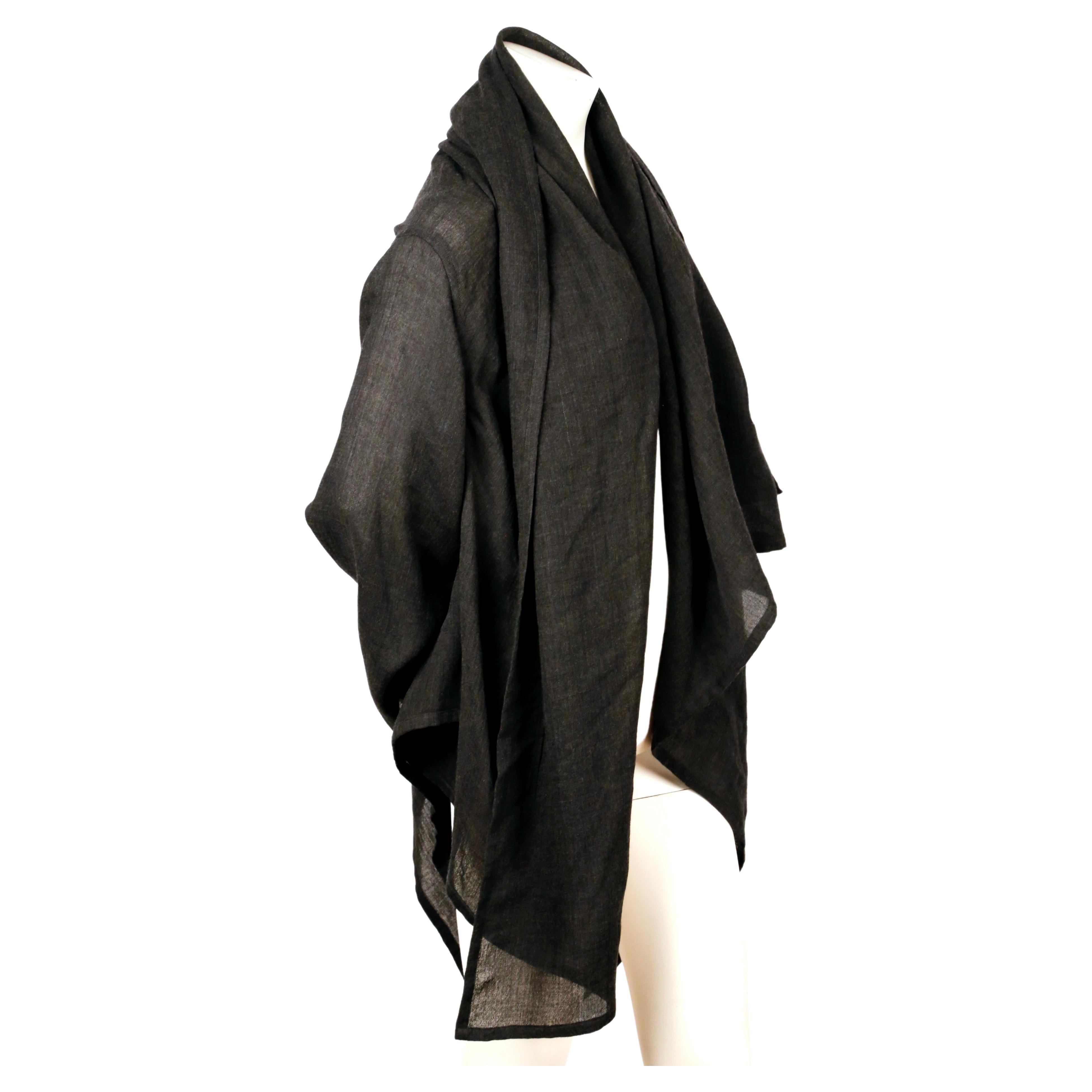 Lightweight, charcoal grey, woven wool wrap jacket with a draped, asymmetrical fit designed by Issey Miyake Plantation. No size is indicated however this fits most sizes due to the design. No fabric content label is present. Made in Japan. Very good