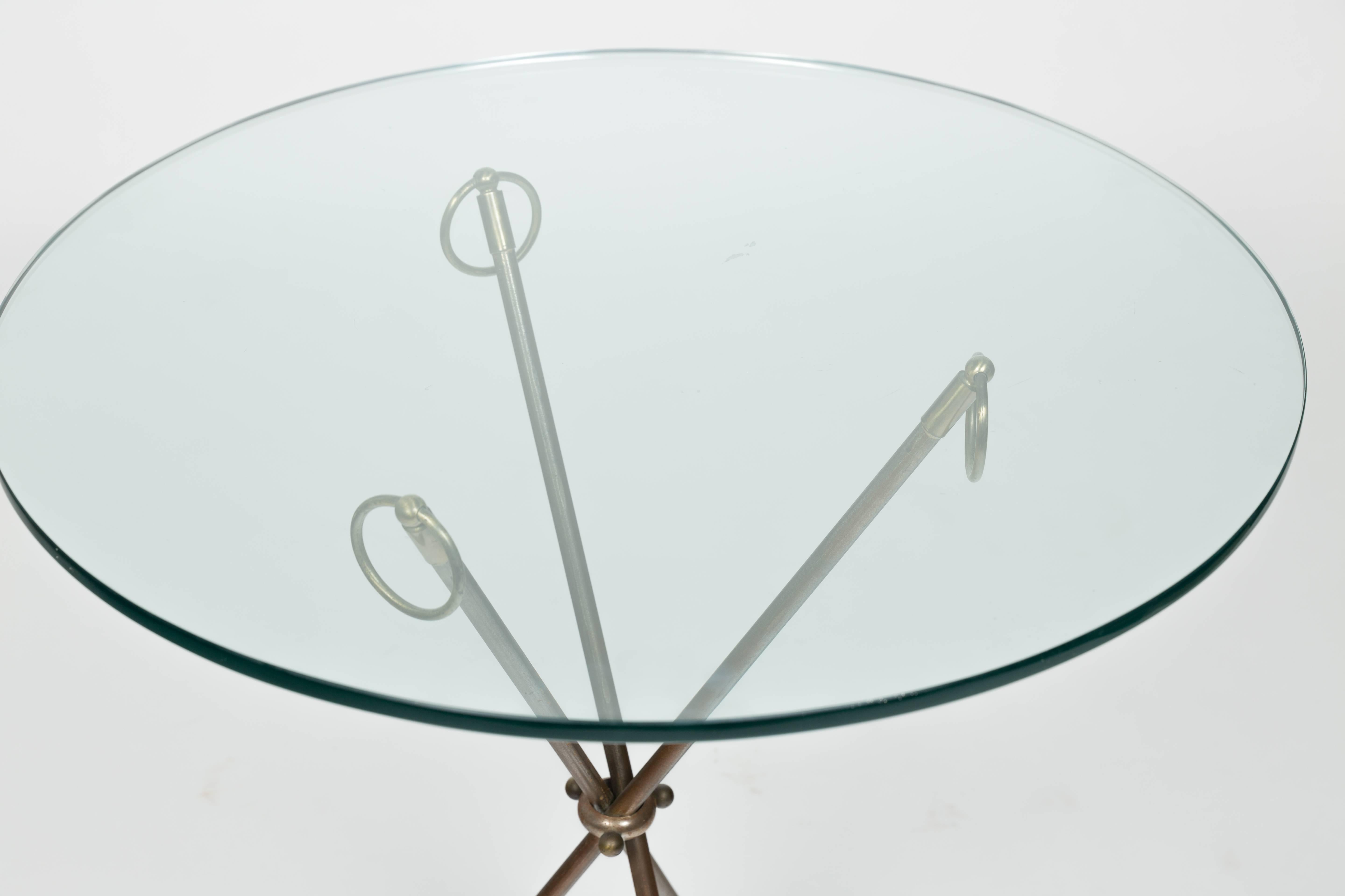 1980s classical glass top tri-pod table from Italy .Base folds up. Bought from Bloomingdales.
 