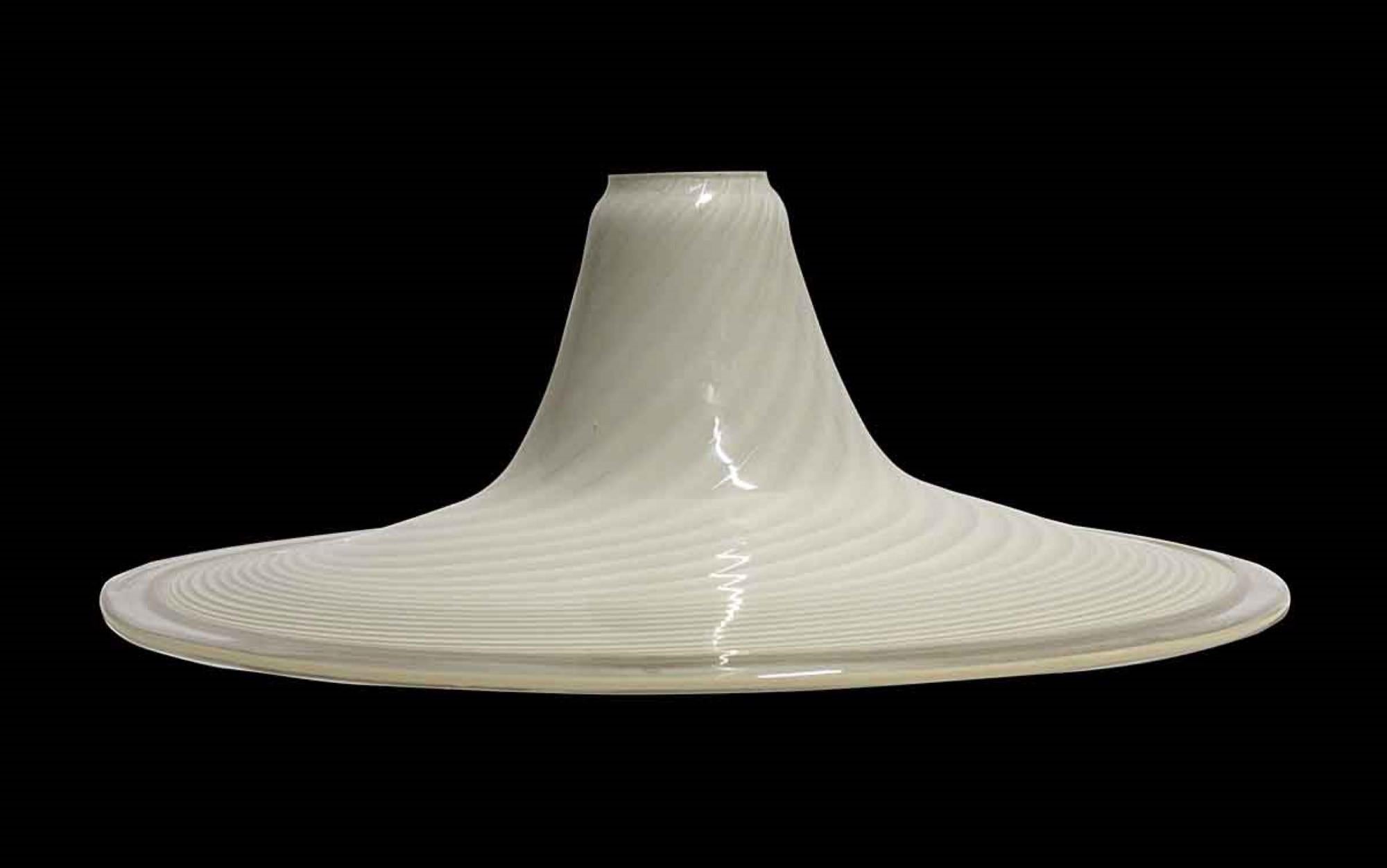 This Mid-Century Modern style Murano shade has almond and tan colored swirls. Accepts a 3.25 inch diameter fitter. This can be seen at our 400 Gilligan St location in Scranton, PA. 