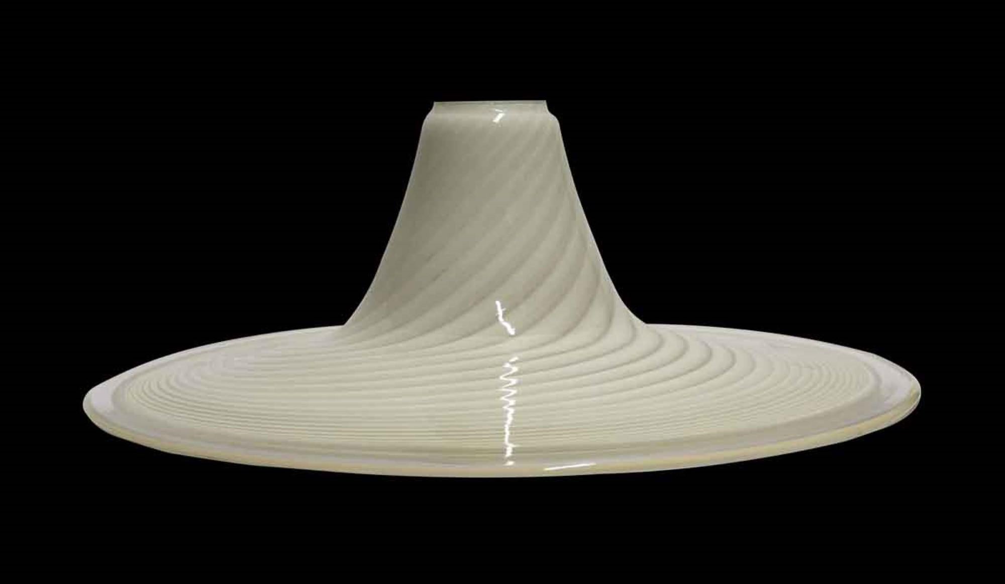 1980s Italian Mid-Century Modern style hand blown Murano shade featuring a light alternating vanilla swirl pattern with a clear flat brim. Accepts a 3.25 inch diameter fitter. This can be seen at our 400 Gilligan St location in Scranton, PA.