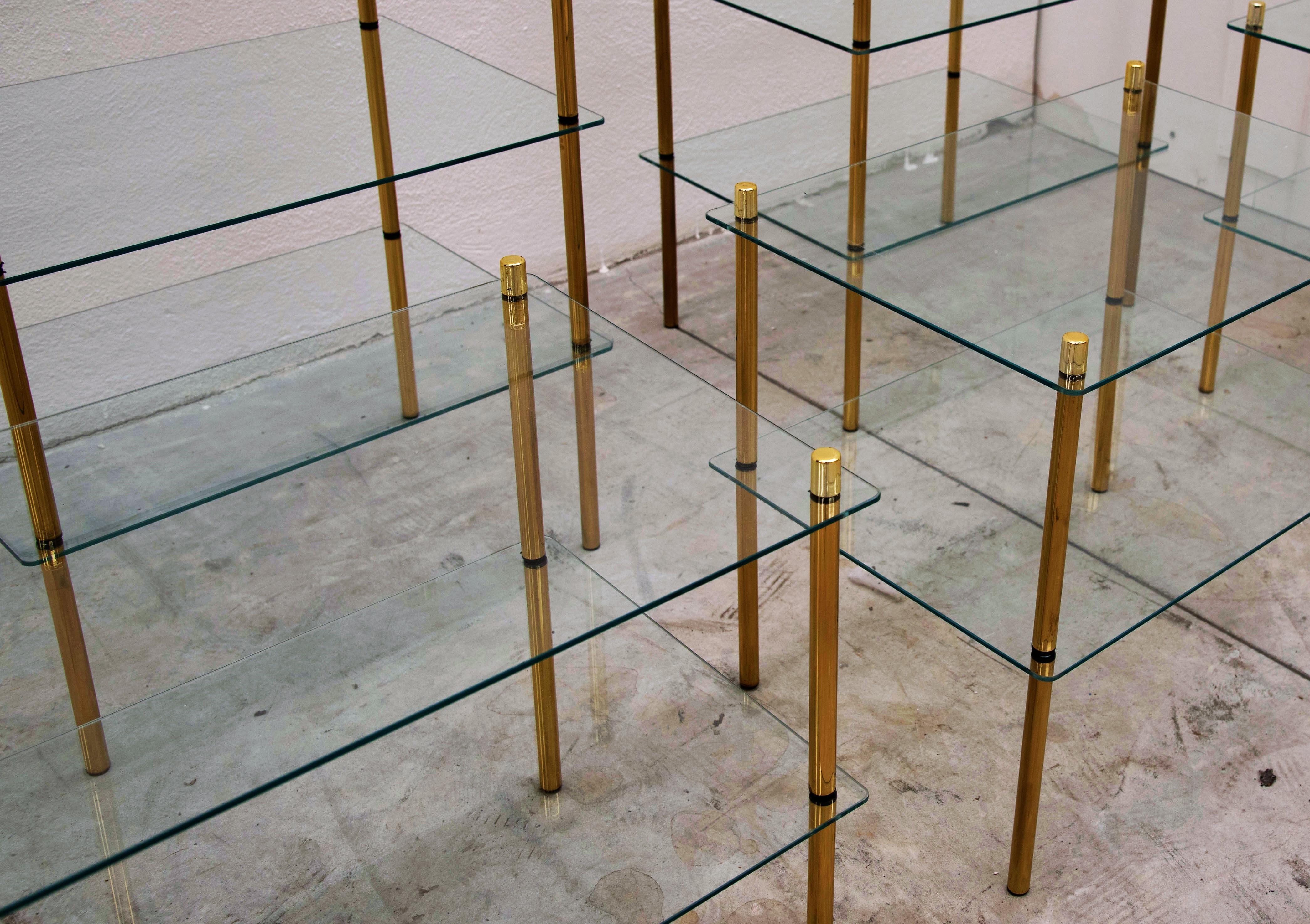 Beautiful brass and glass side tables, manufactured in the 1980s in Italy. The tables have two glass shelves hold by golden brass sticks. We do also have the three shelves version available. The conditions are excellent. As can be seen from the