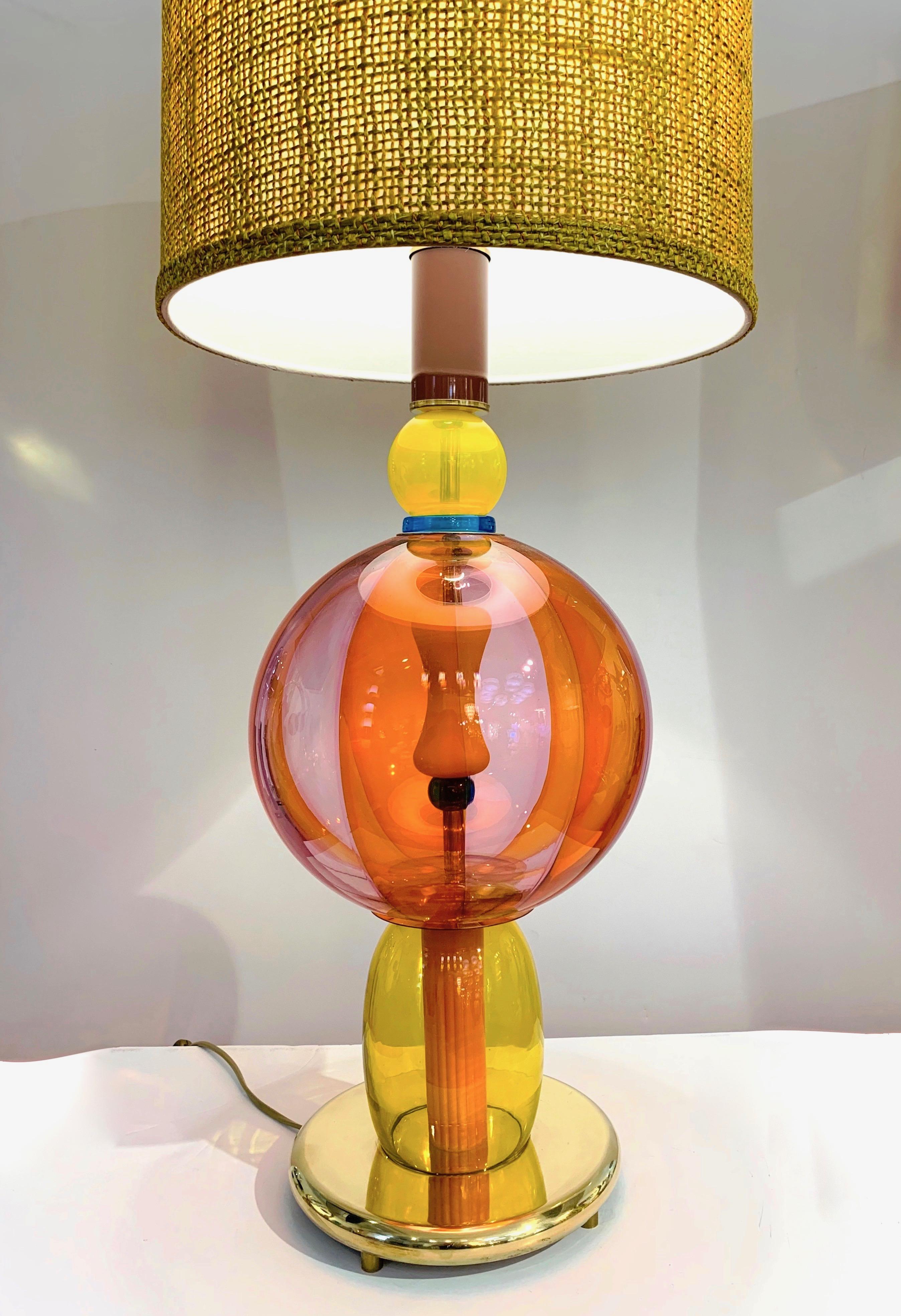 1980s one-of-a-kind Memphis style Italian table lamp, entirely handcrafted, consisting of a succession of different glass elements in blown Murano Art glass in various shapes with a typical Pop Art palette in orange, yellow, purple plum with a