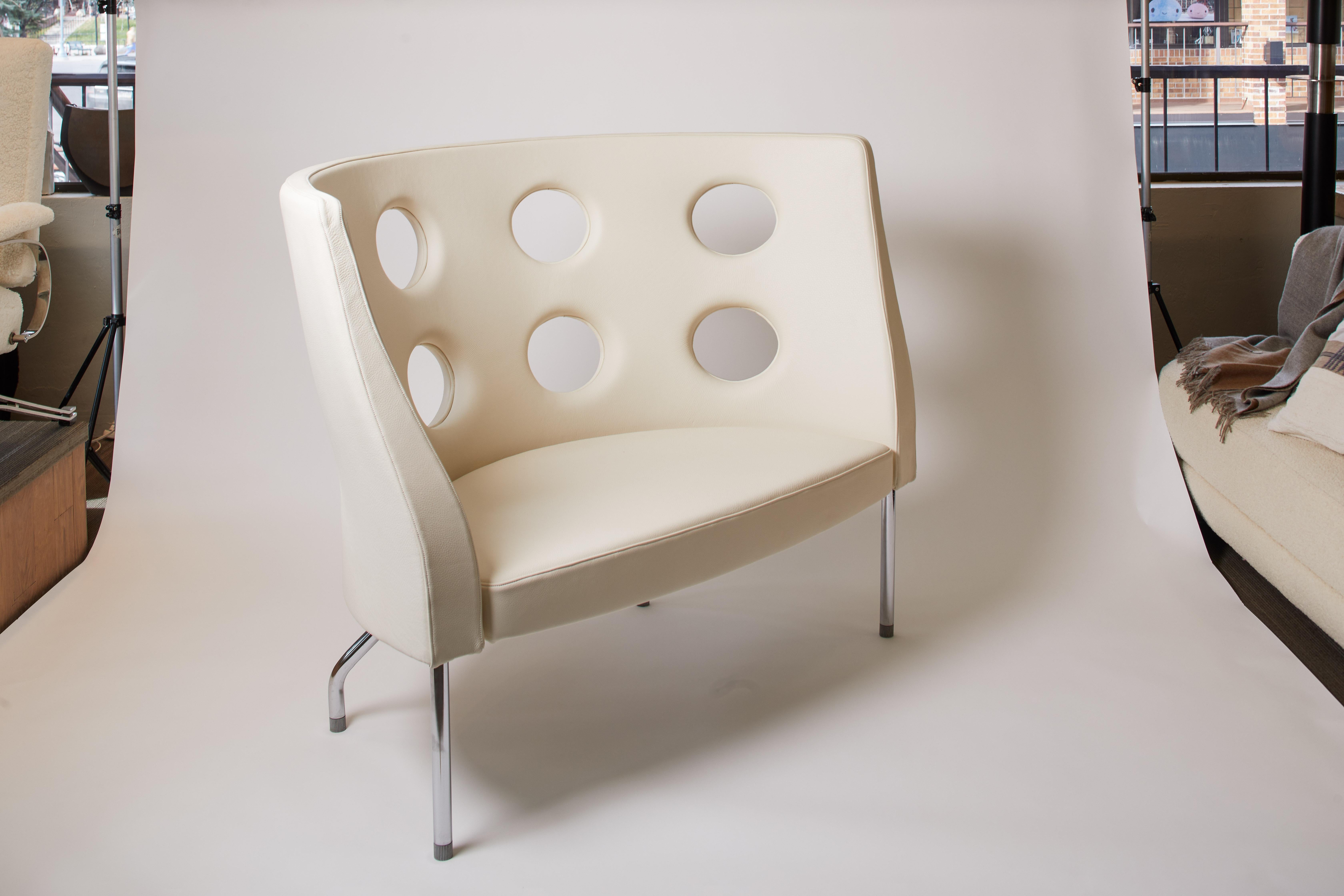 1980s Italian reupholstered/restored ivory leather settee by Paolo Rizzatto for Alias, Flexus collection. Circular cutouts in the back of the chair create a modern look. Excellent condition.