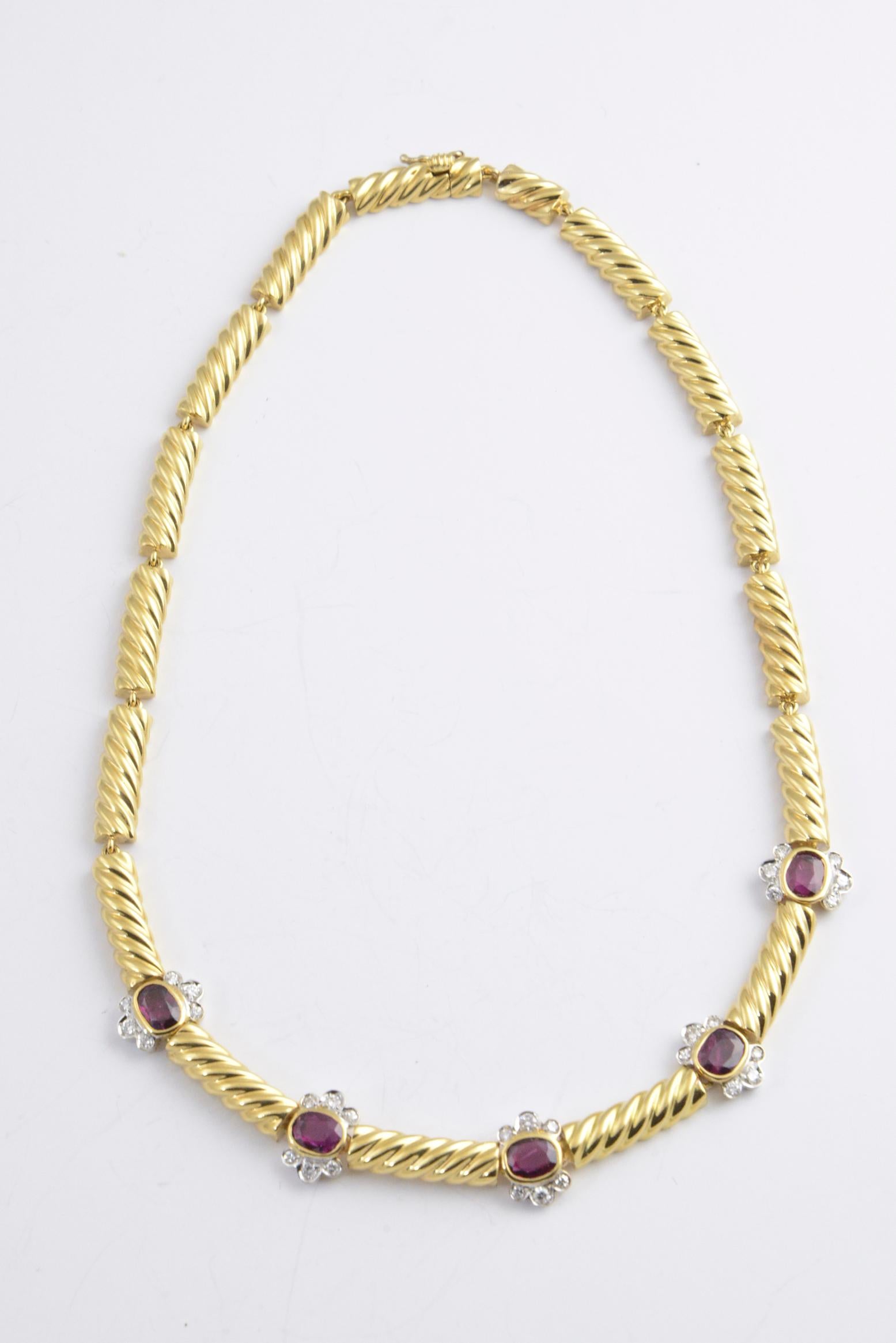 1980s Italian 18K yellow gold necklace set with rubies. Each ruby is surrounded by six diamonds. Diamonds, .02 carats each. Marked: 18K Italy.

There is a matching ring and necklace sold separately.  There is a picture so you can view full set.

