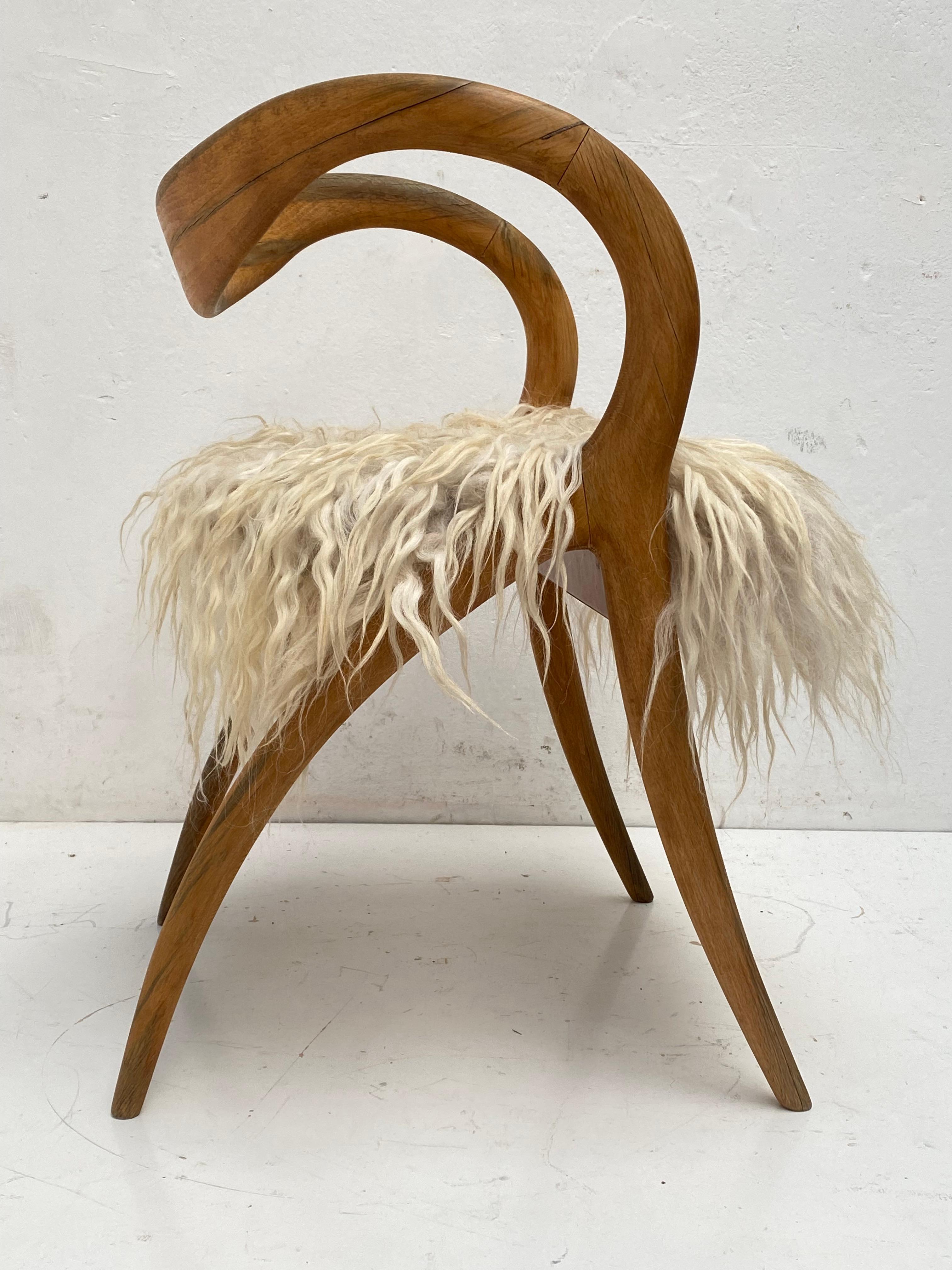 A beautiful side chair by Italian designer A. Sibau

Lovely sculptural design in solid Birch wood

We upholstered this chair with animal friendly hand felted Islandic Sheep wool to give it an organic appearance that is matching with the sculptural