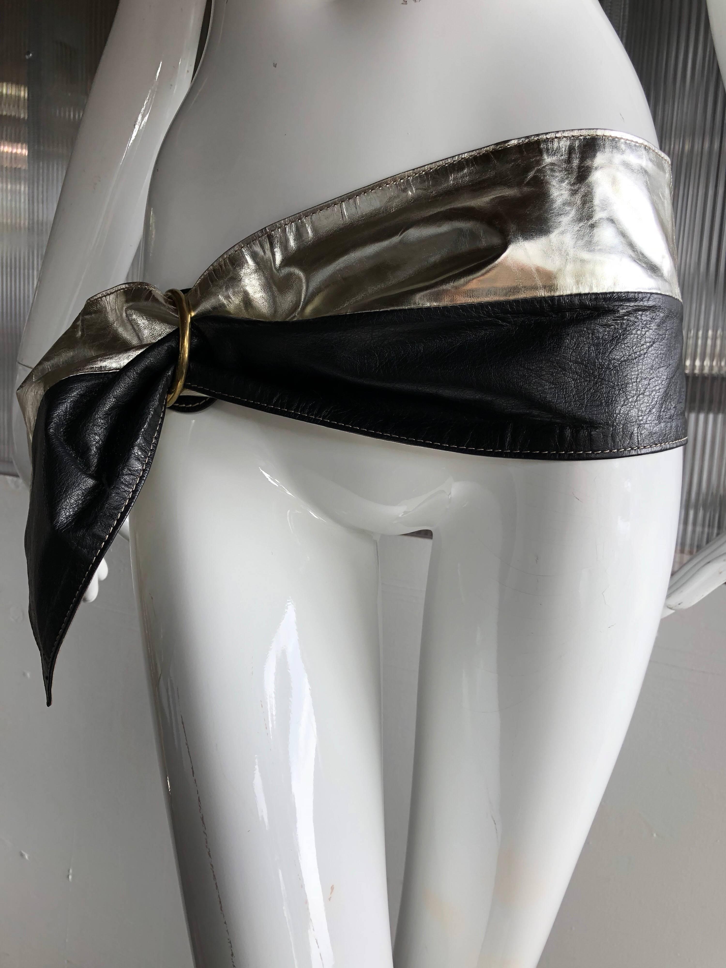 Dramatic 1980s silver and black leather belt made in Italy. One metal ring hardware adjusts the belt to desired size and width. 
Bold and beautiful!