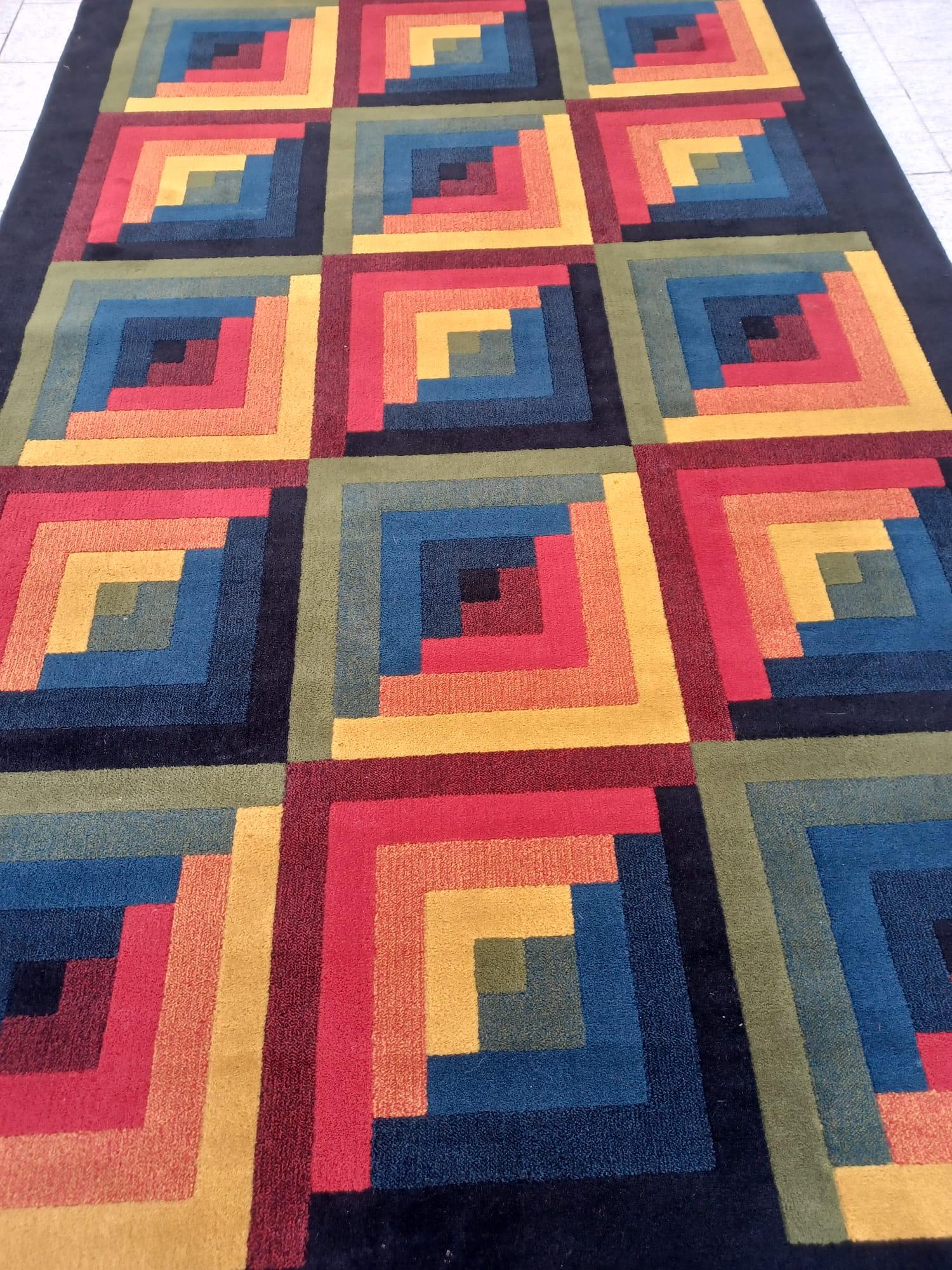 This Ottavio Missoni vintage rug was made in the 80s in pure virgin wool by the company T&J Vestor, founded in 1921 by Rosita Missoni, and now acquired by Missoni Home.
thi beautiful optical rug has geometric patterns that form squares with bright