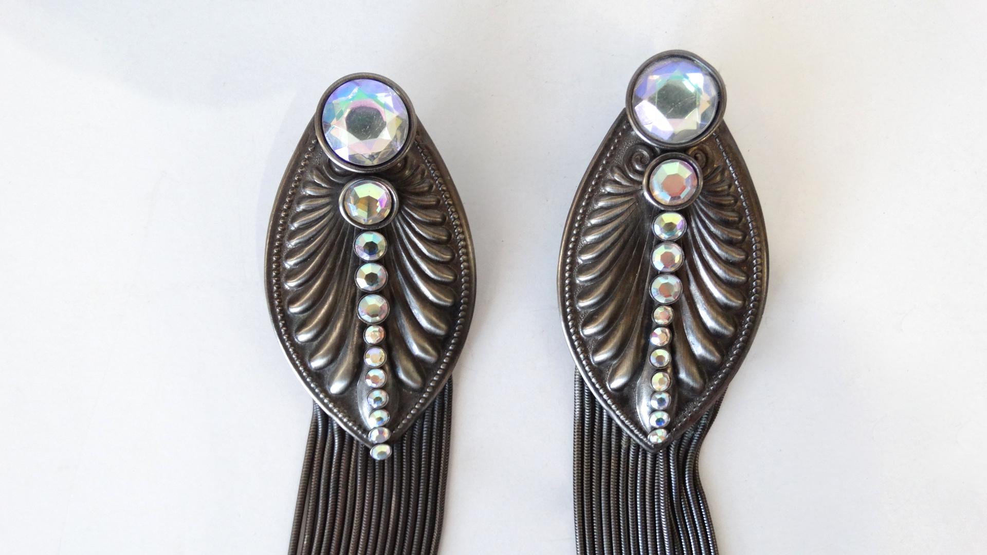 Add Some 80s To Your Next Look With These Amazing Earrings! Designed by Jack Smile, the setting is an elongated oval shape with pointed ends and decorative detailing along the trim and front face. Rhinestones decreasing in size are the center