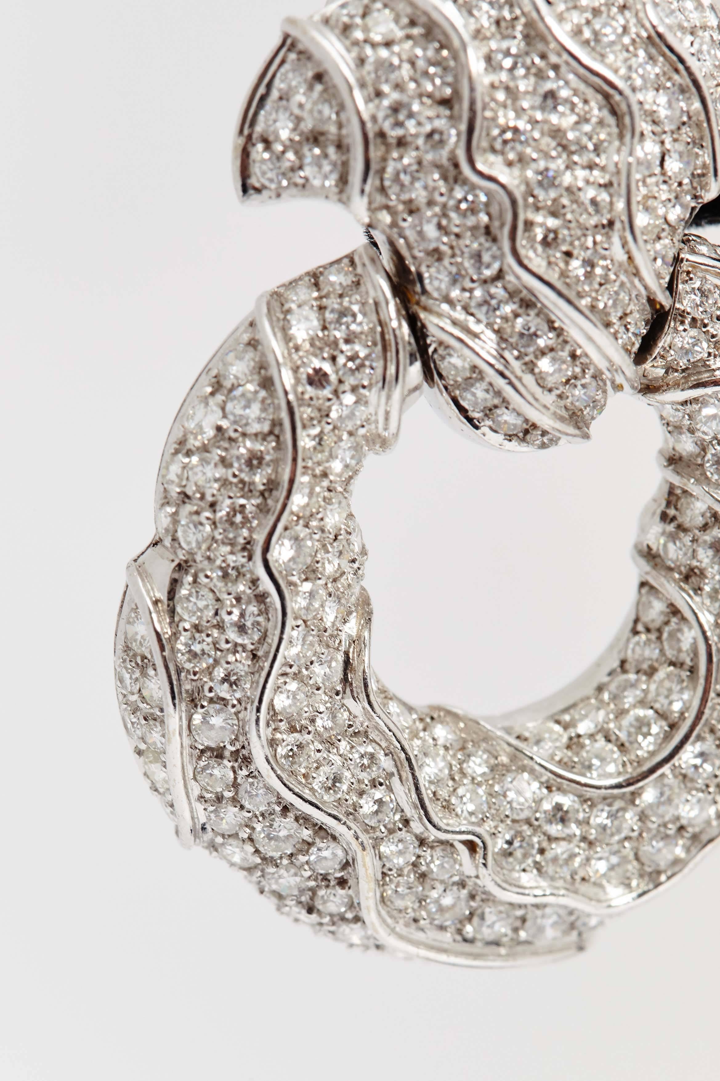 A pair of impressive ear pendants of undulated design, with fine quality brilliant cut diamonds mounted on 18kt white gold. Made in Geneva, by Jahan, circa 1980. 