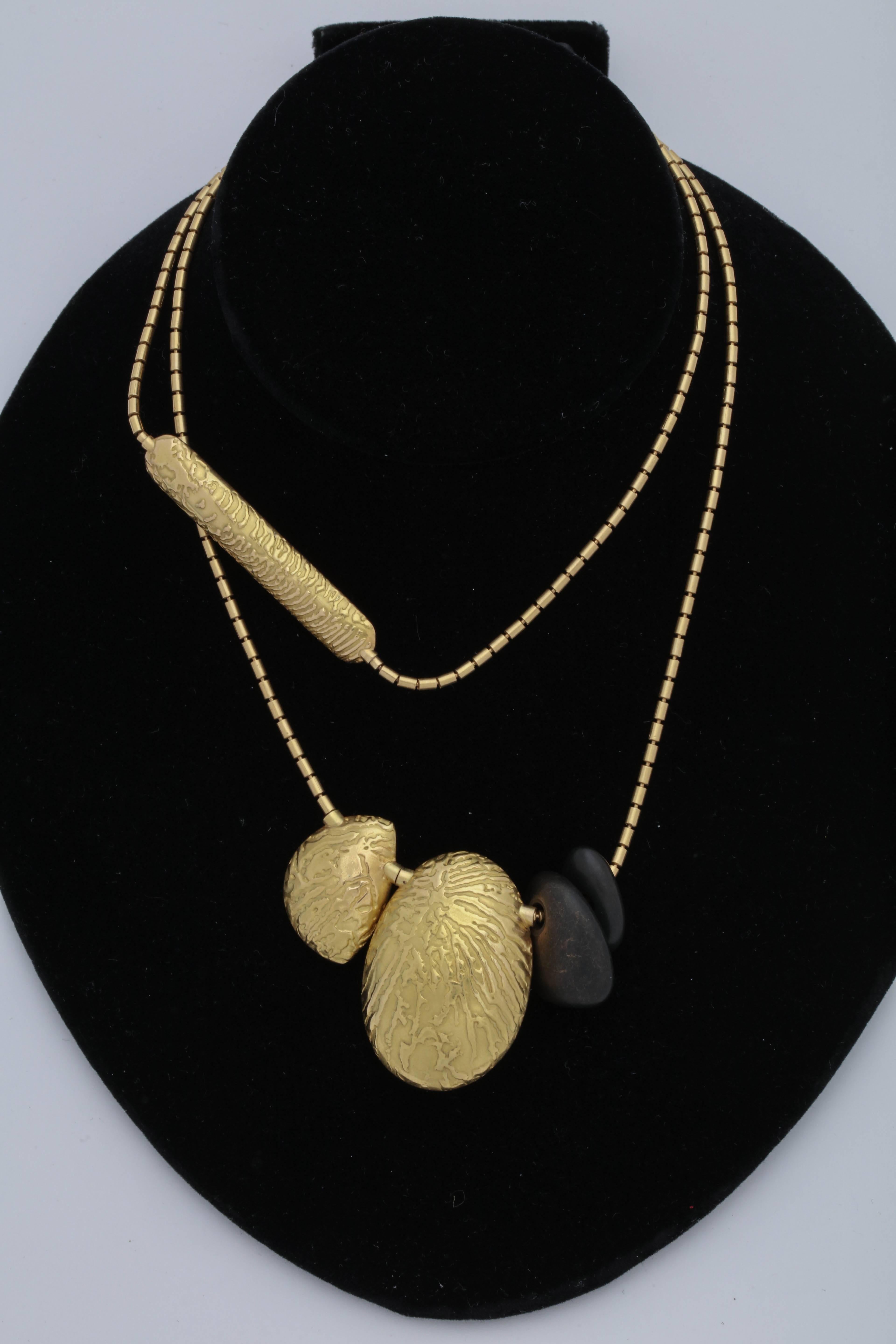 One Unisex Cool And Hip Designer Necklace Created In Two Types Of Gold,On One side It Is Made In 18kt High Polish Yellow Gold and The Other side is Created In A HandHammered Textured 18kt Yellow Gold Patter. This chain Type Necklace is Also