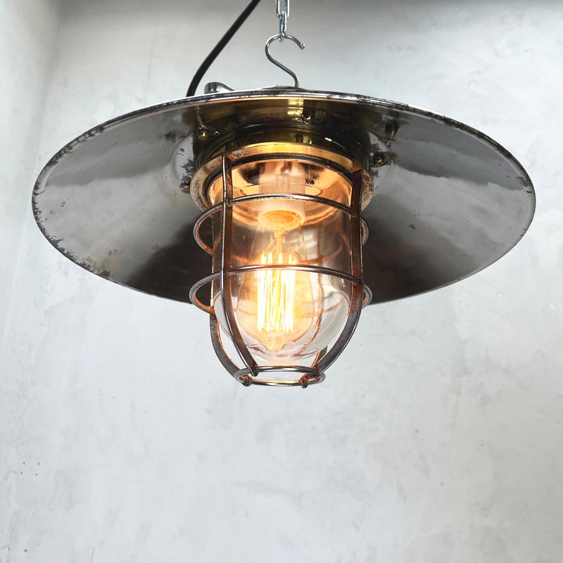 1980's cast steel explosion proof ceiling cage light originating from Osaka Japan made by Kokosha.

Add some industrial charm to your kitchen island with a row of these metal cage lights. Or illuminate public areas such as bars, restaurants or