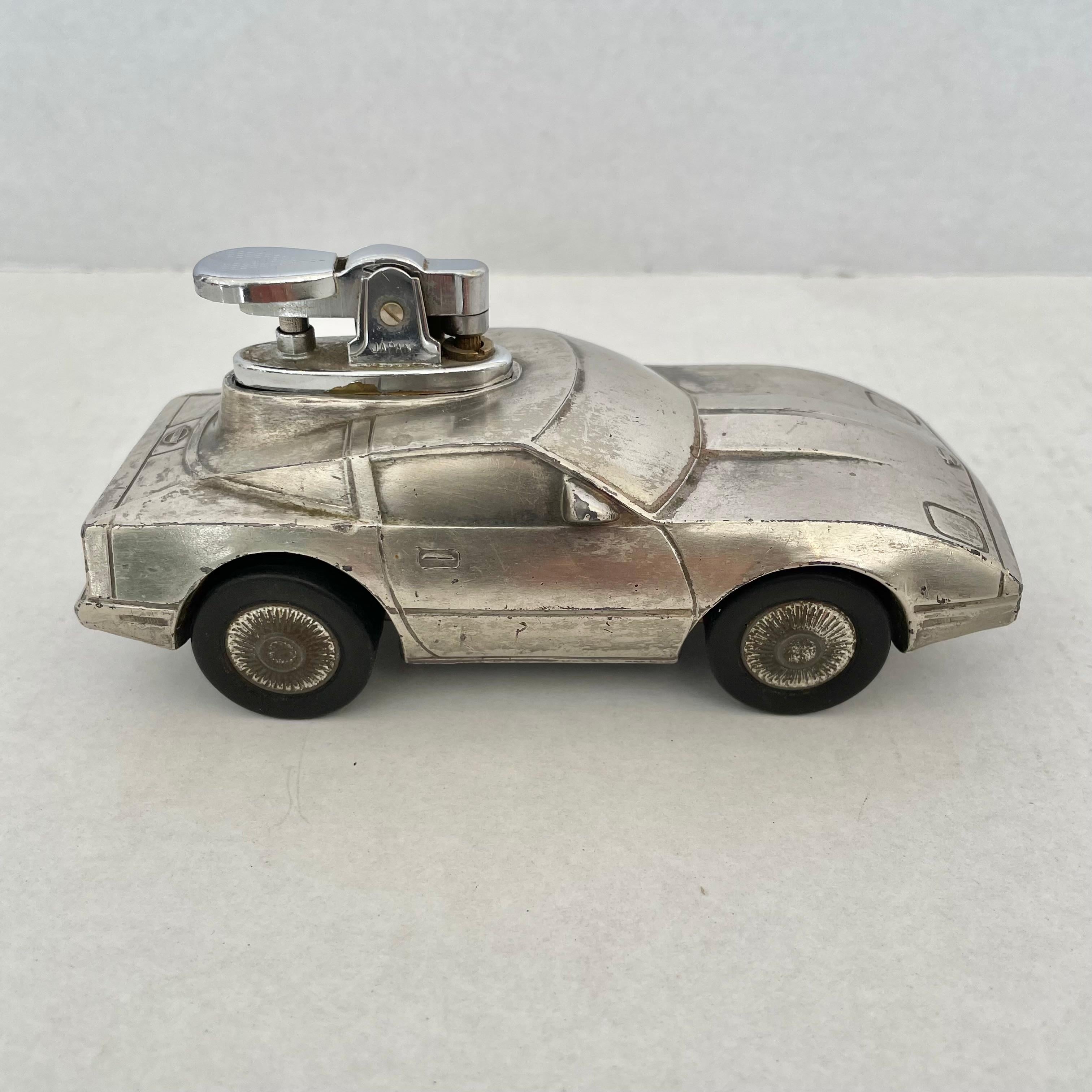 Cool vintage table lighter in the shape of a 1984 Corvette. Rubber wheels with tread detailing. License plate reads Corvette on the back and 1984 in the front. Cool tobacco accessory and conversation piece. Working lighter. Good vintage condition.