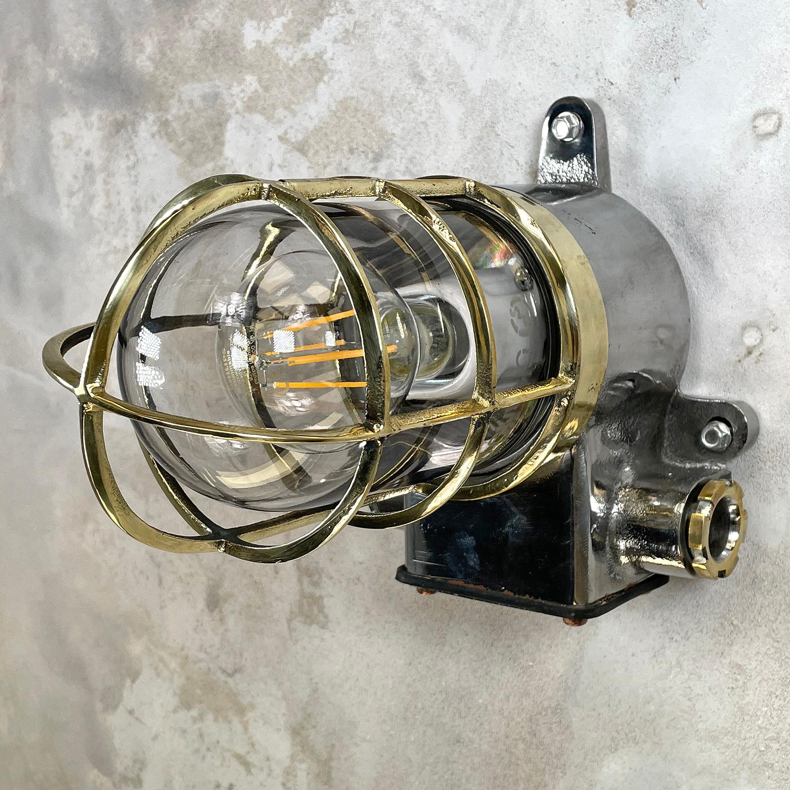 A vintage Industrial 1980s Japanese cast iron wall sconce with a brass cage and glass shade manufactured by Kokosha. 
Reclaimed and professionally restored by hand in UK ready for contemporary interiors. 
Perfect wall lighting to add some rustic